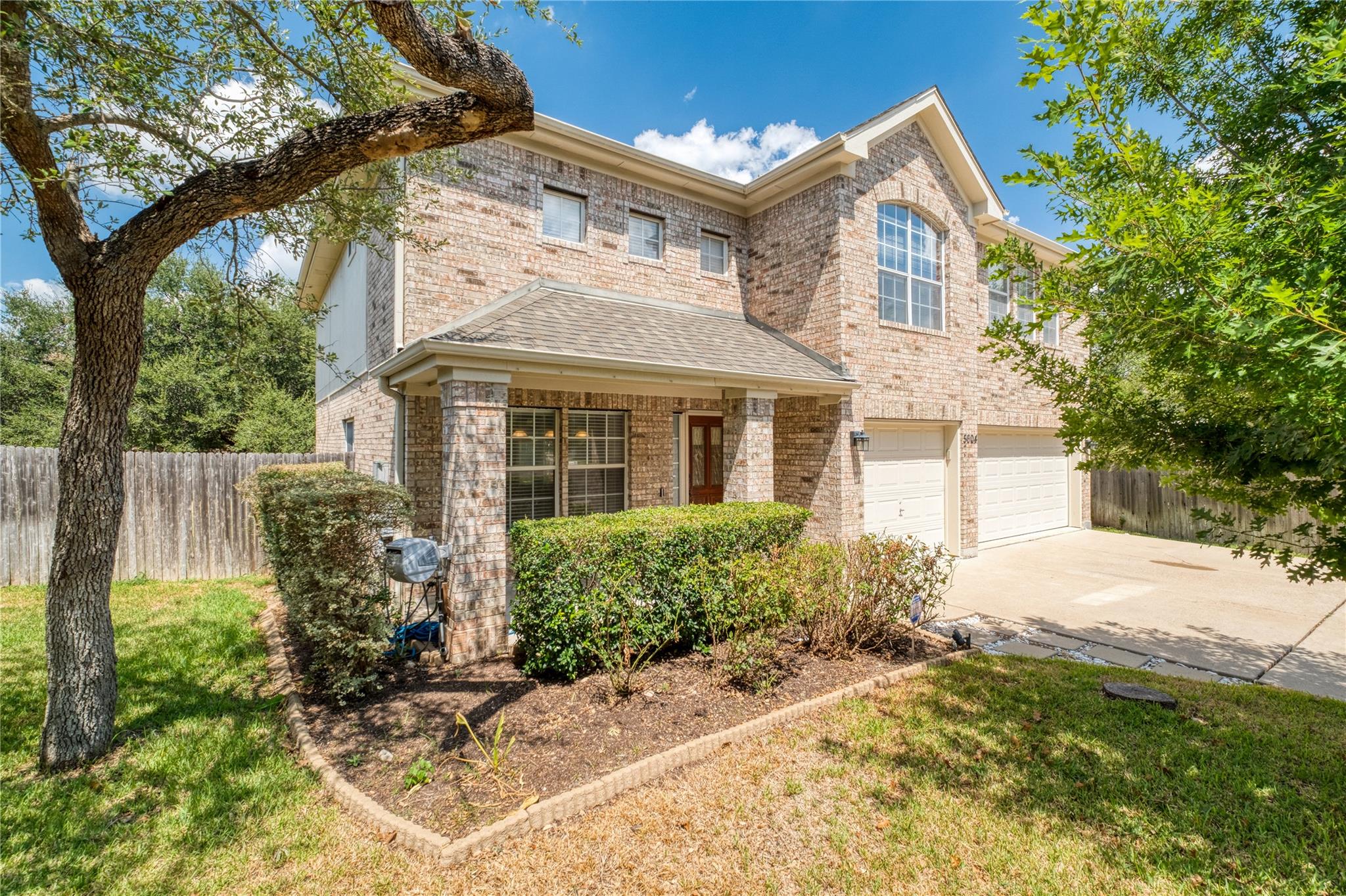 Elegant brick exterior pairs with a welcoming fro