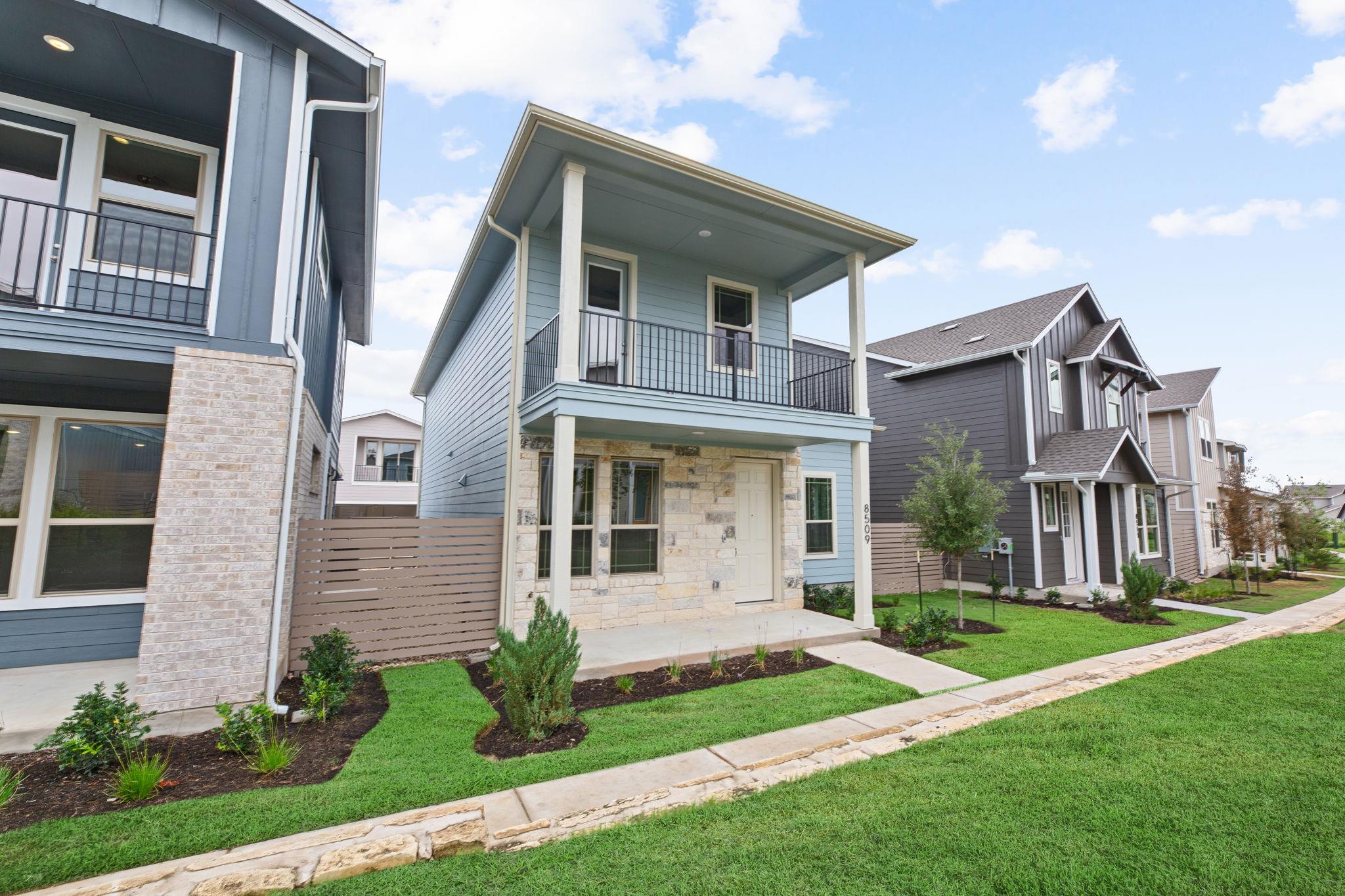 Two-story residence featuring light blue siding a