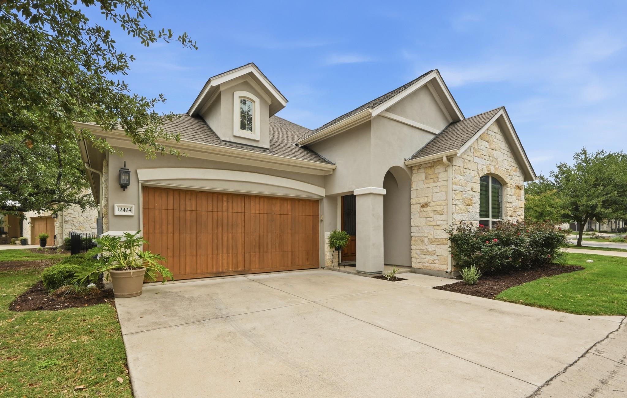 Front exterior featuring a stucco and stone facad