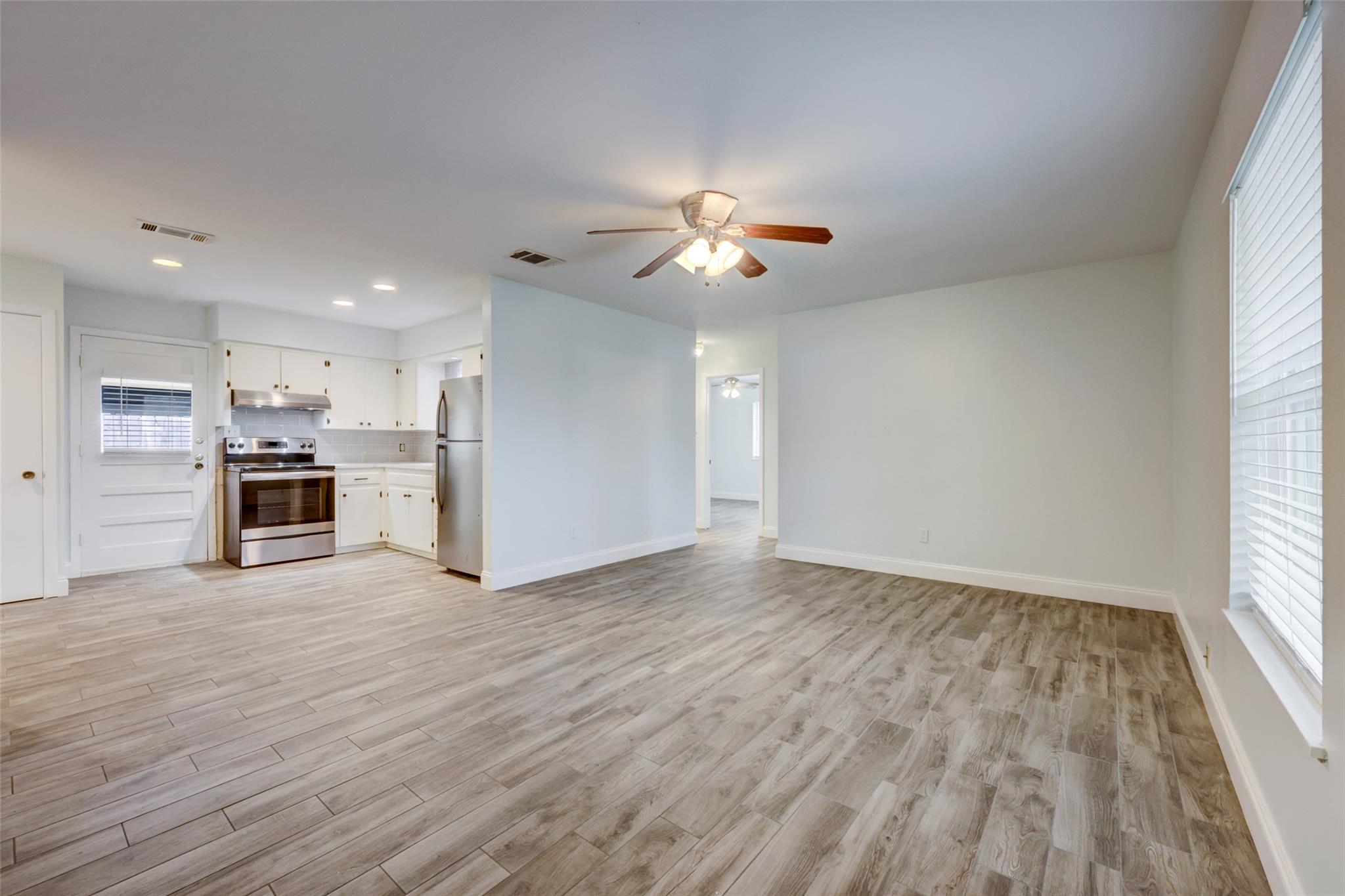 Open-concept living space featuring wood-finish t