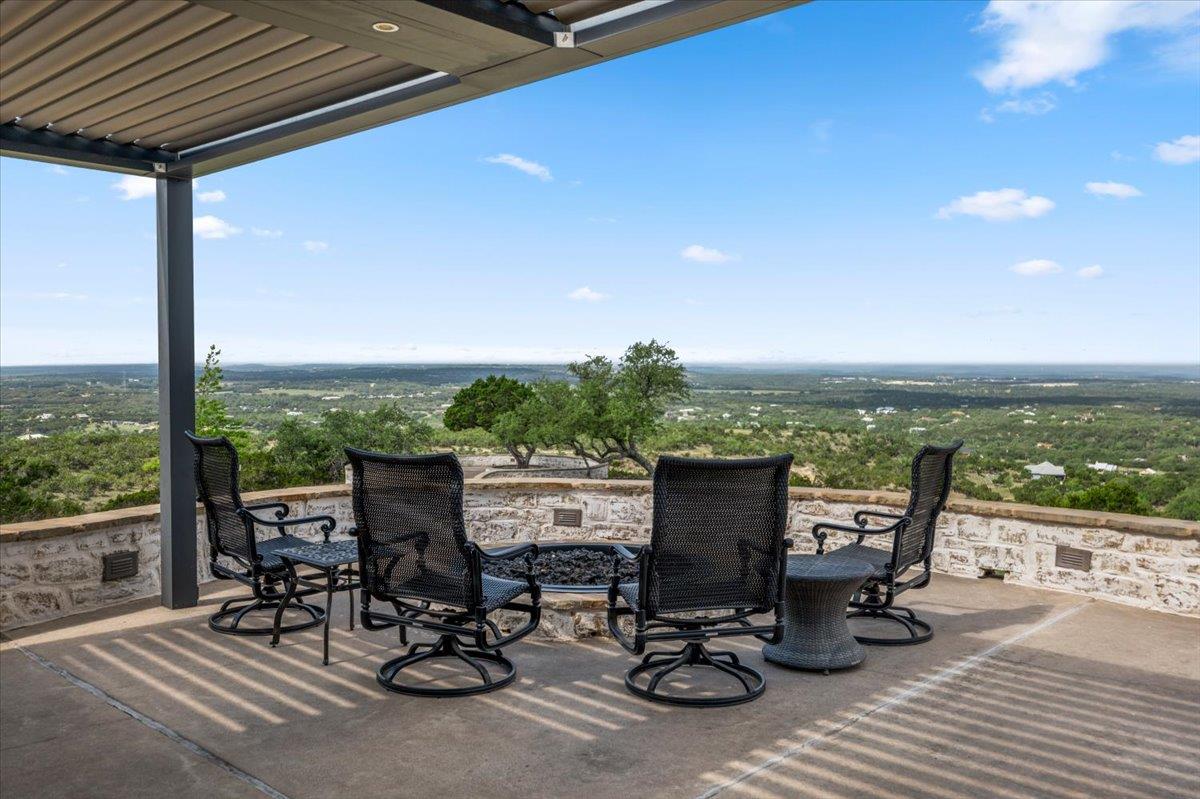 Outdoor patio featuring a covered pergola, concre