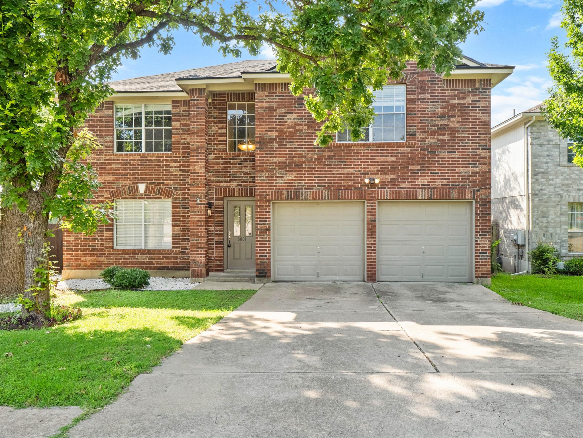 A classic brick exterior, two-story residence wit
