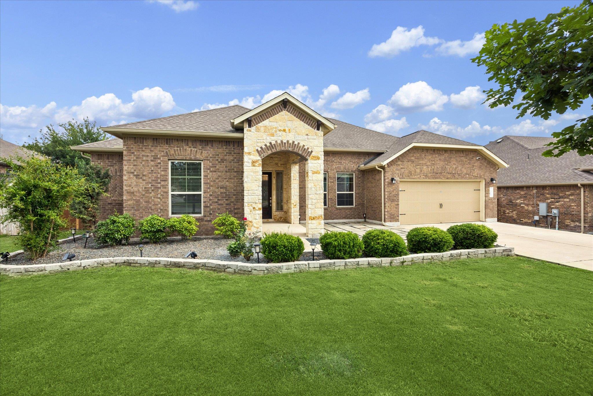 Brick exterior featuring stone accents and a cove