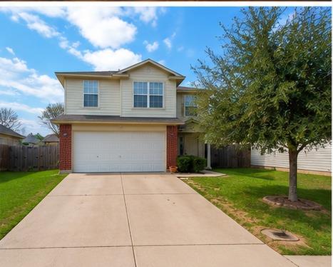 A well-maintained lawn and extended concrete driv