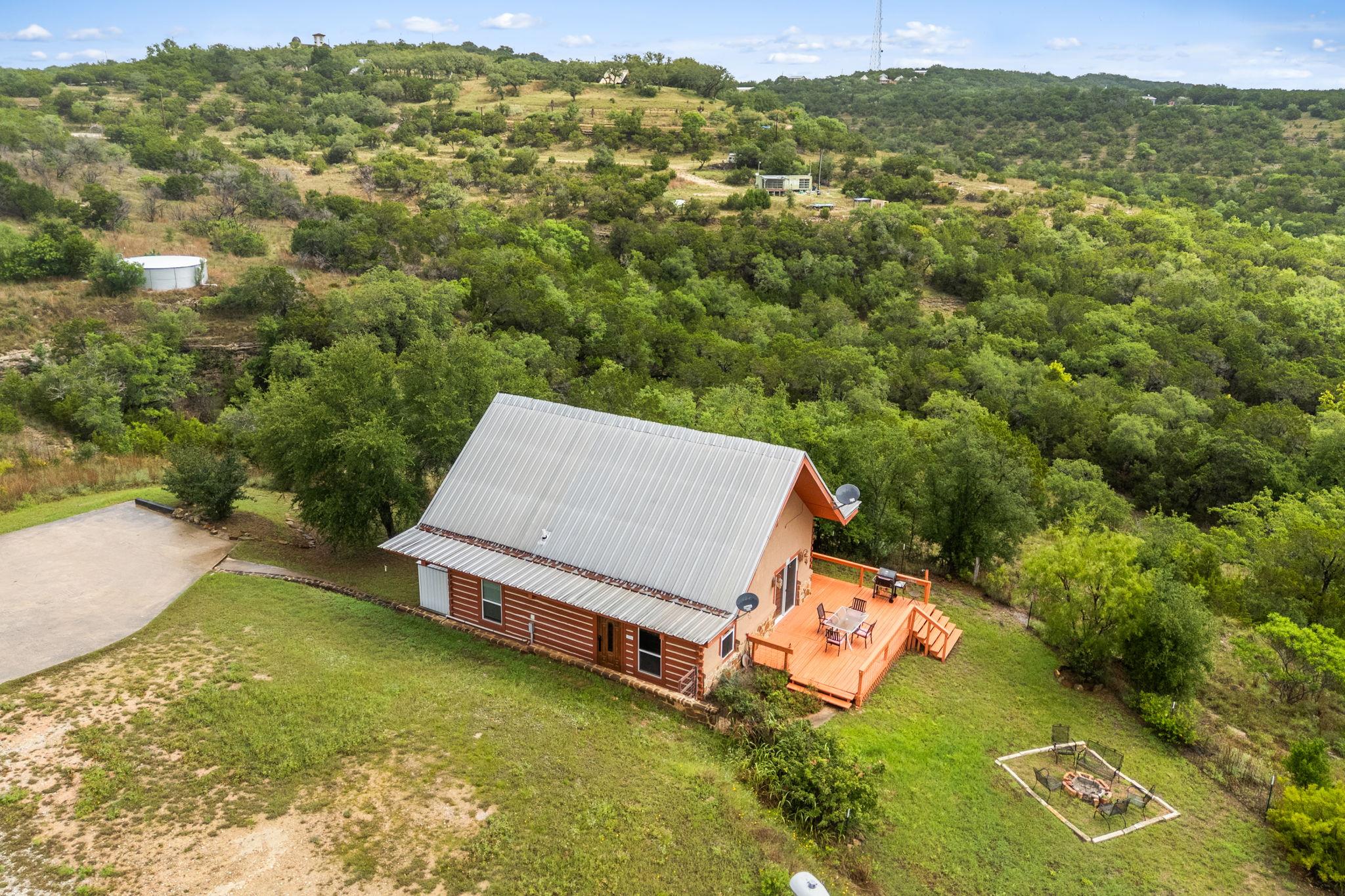Log cabin-style residence featuring a metal roof 