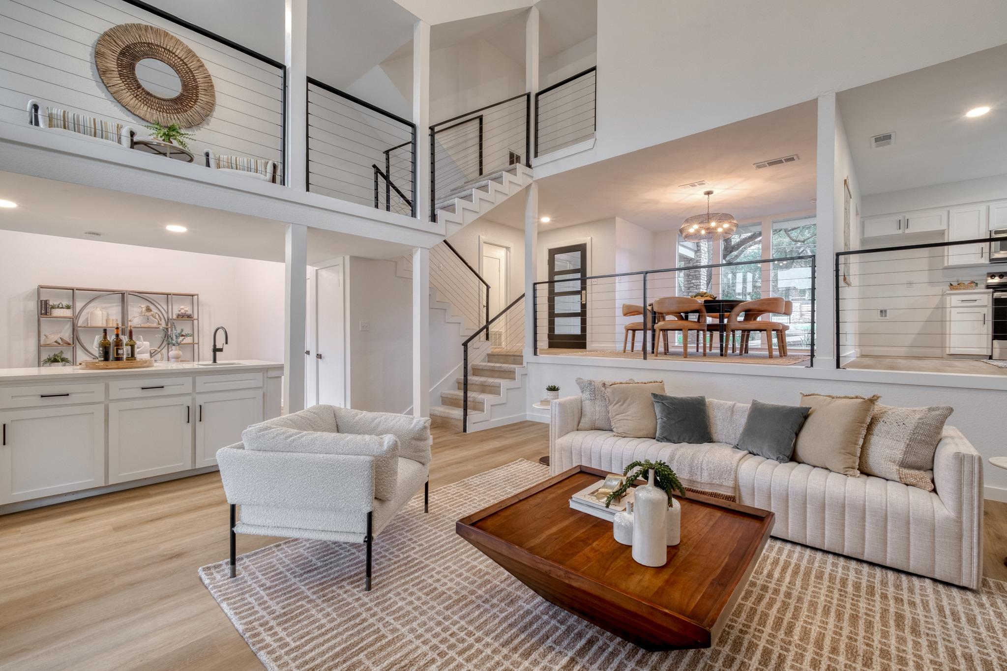 Open-concept living area featuring wood-finish fl