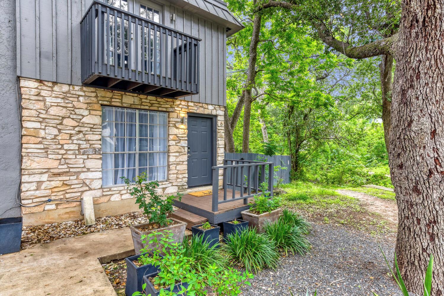 Stone and siding exterior with a second-story bal
