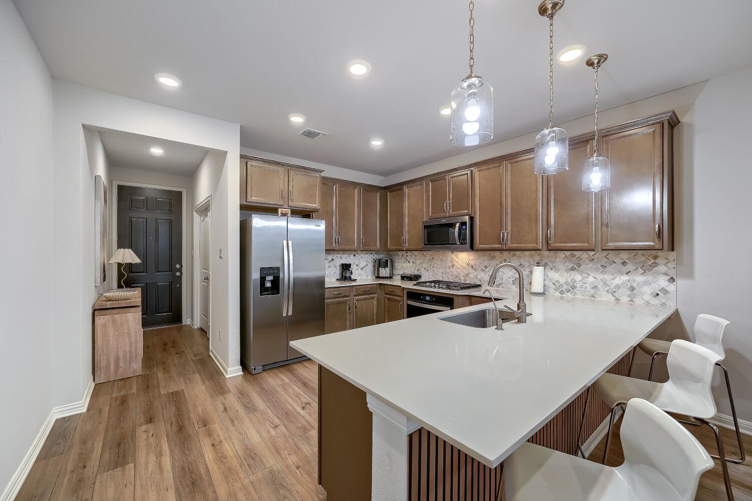 Kitchen featuring stainless steel appliances, woo
