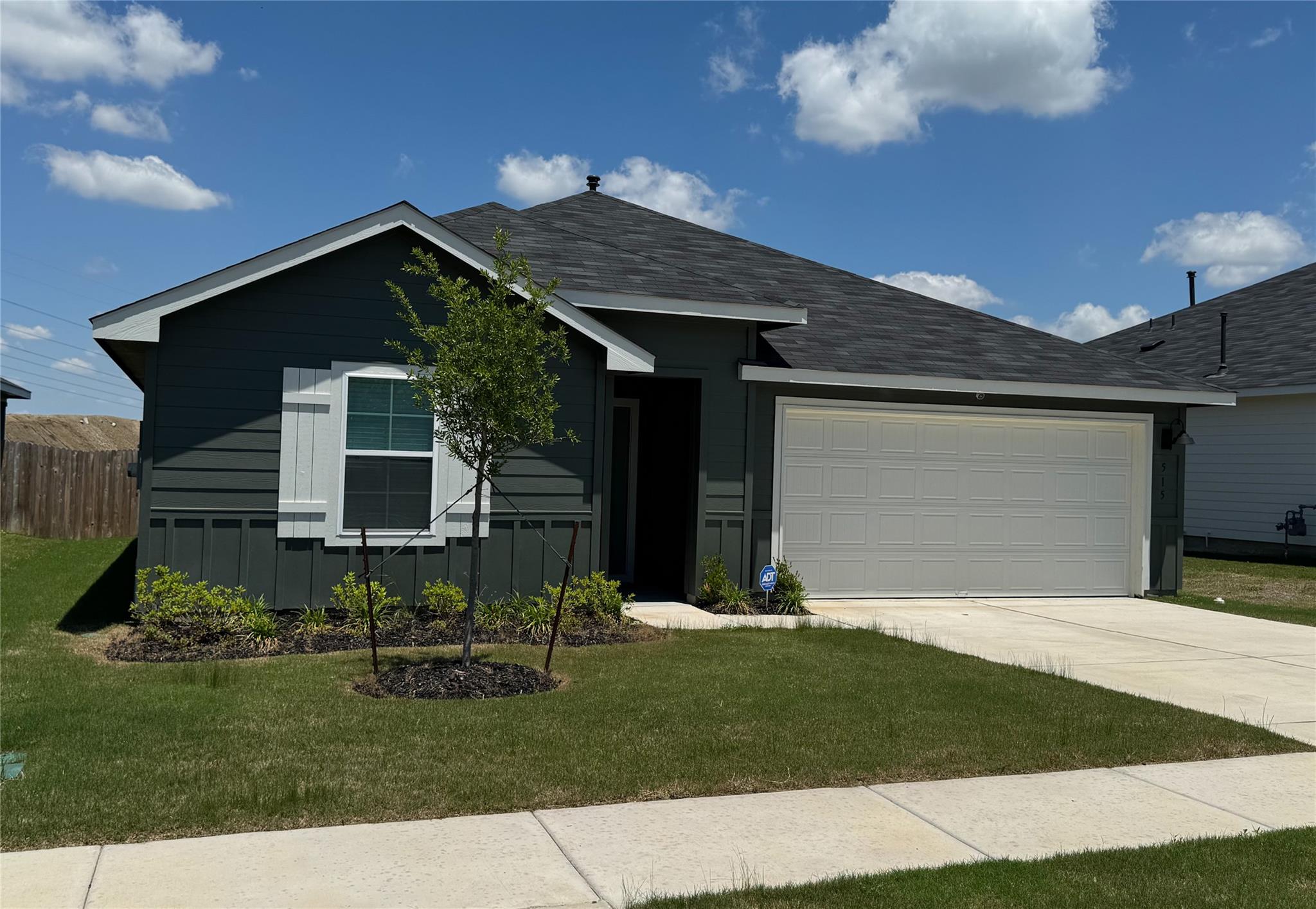 Single-story residence featuring dark siding with