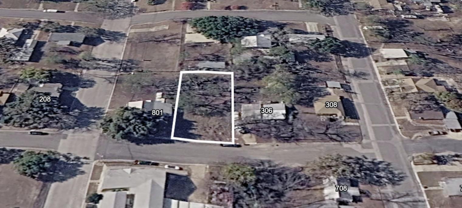 Cleared lot featuring mature trees, a rectangular