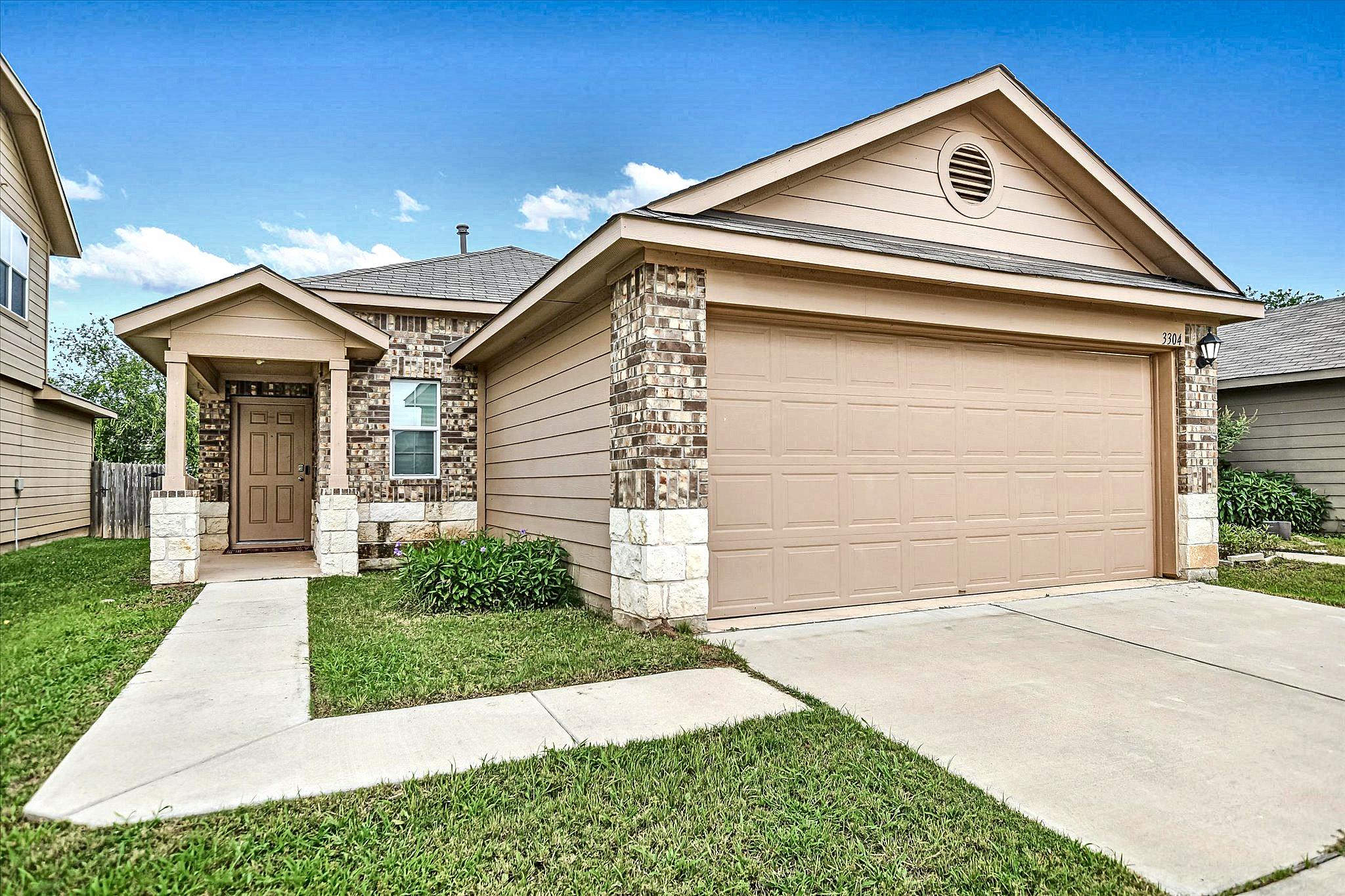 A welcoming facade features a covered entry, inte