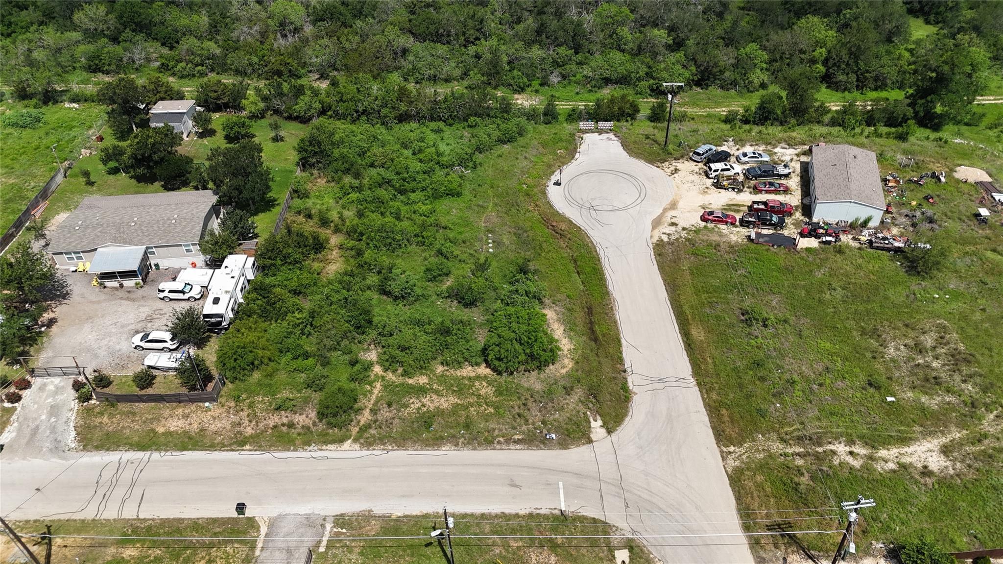 Expansive lot featuring a paved road entrance and