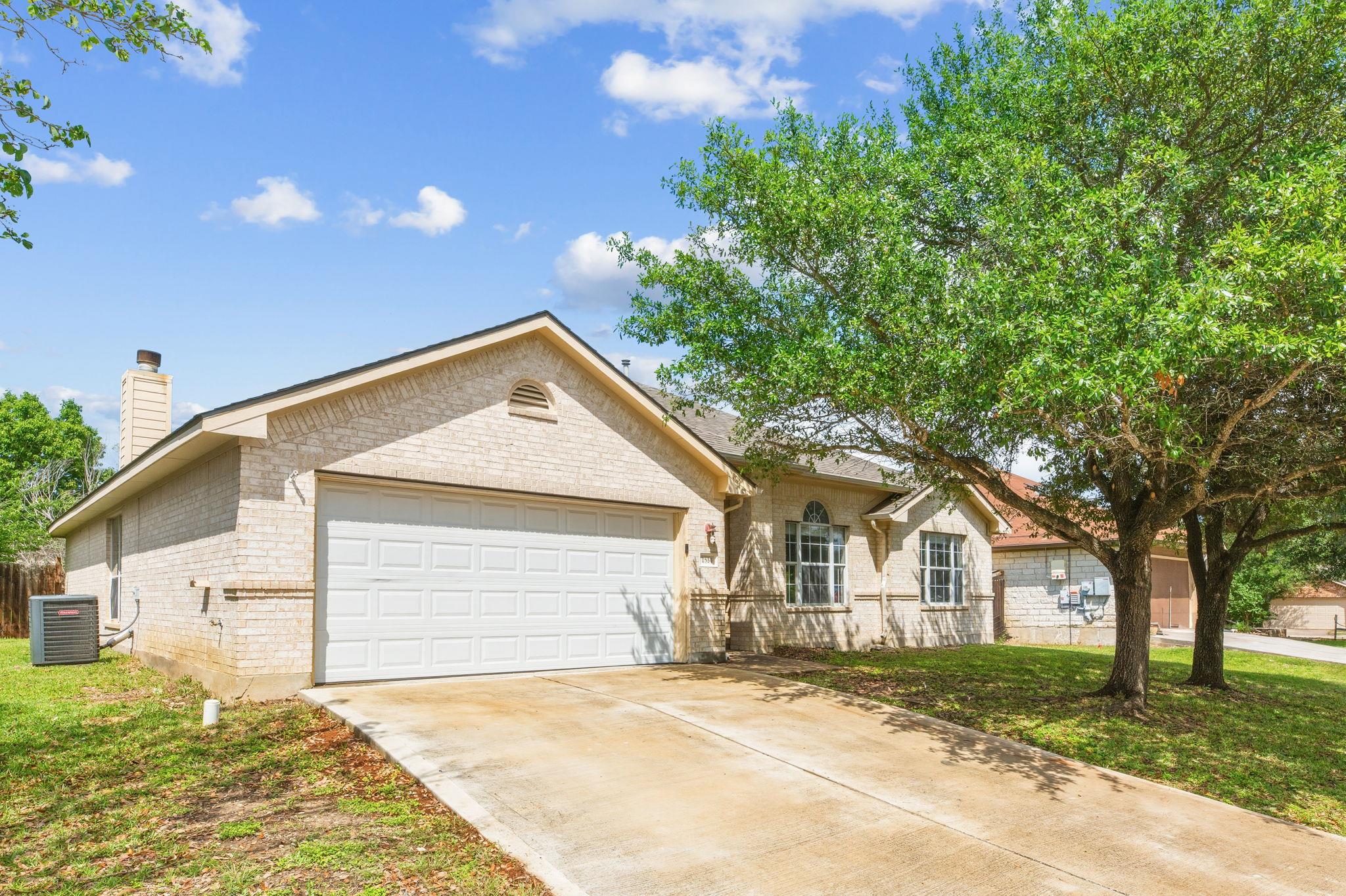 Brick-veneer exterior featuring a two-car garage,