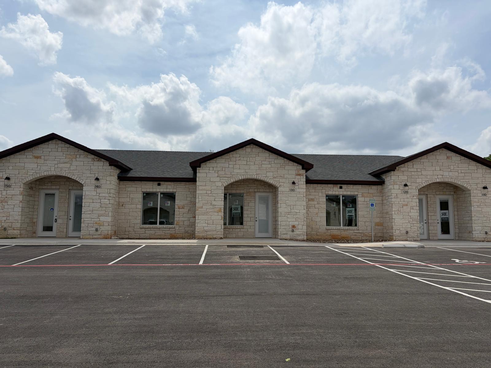 Stone facade with multiple arched entryways and a