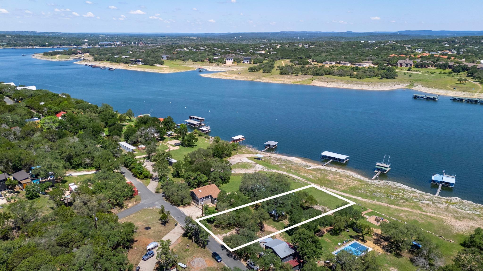 Waterfront property featuring a wooded lot, a cle