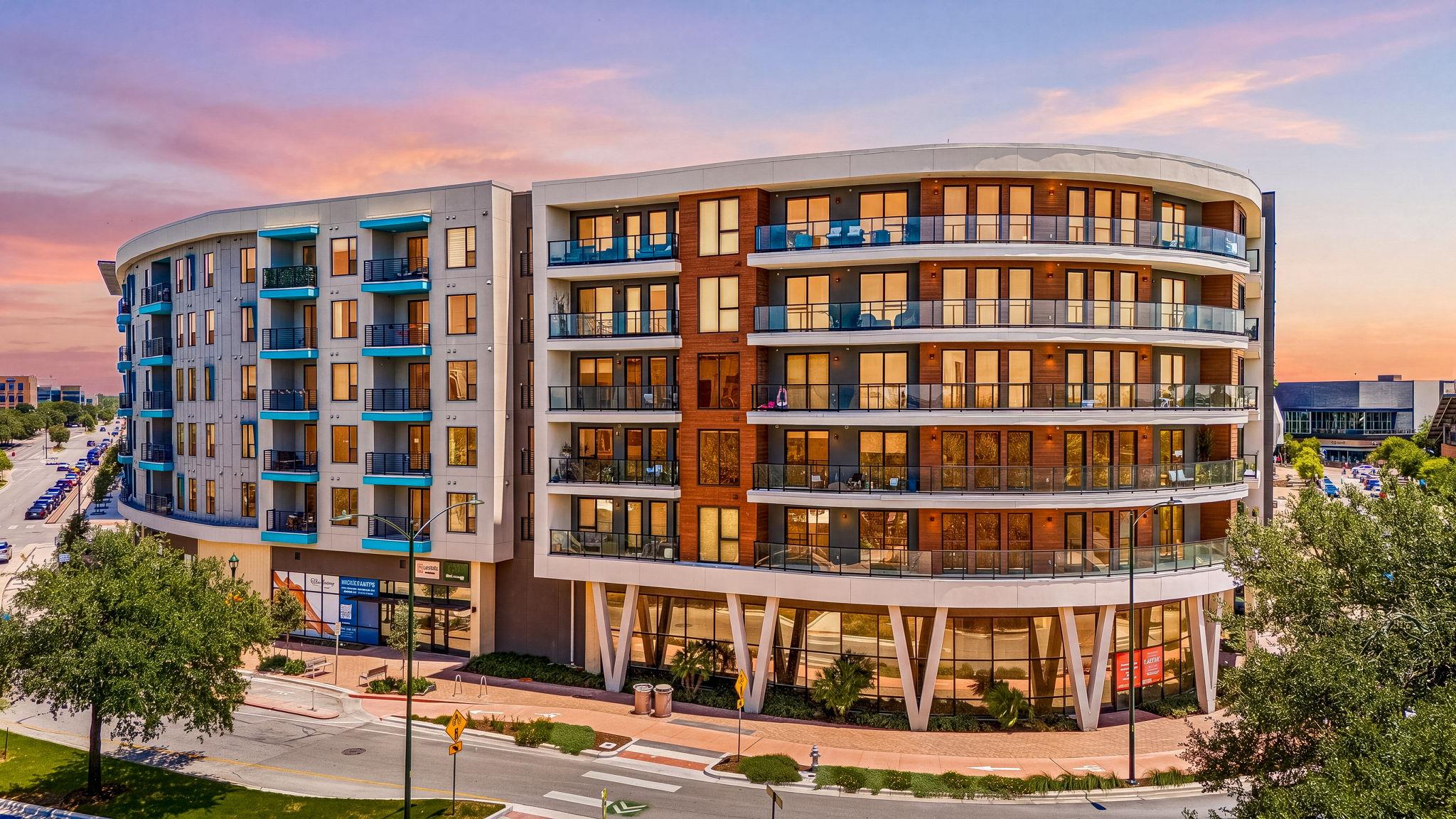 Contemporary multi-story building featuring a cur
