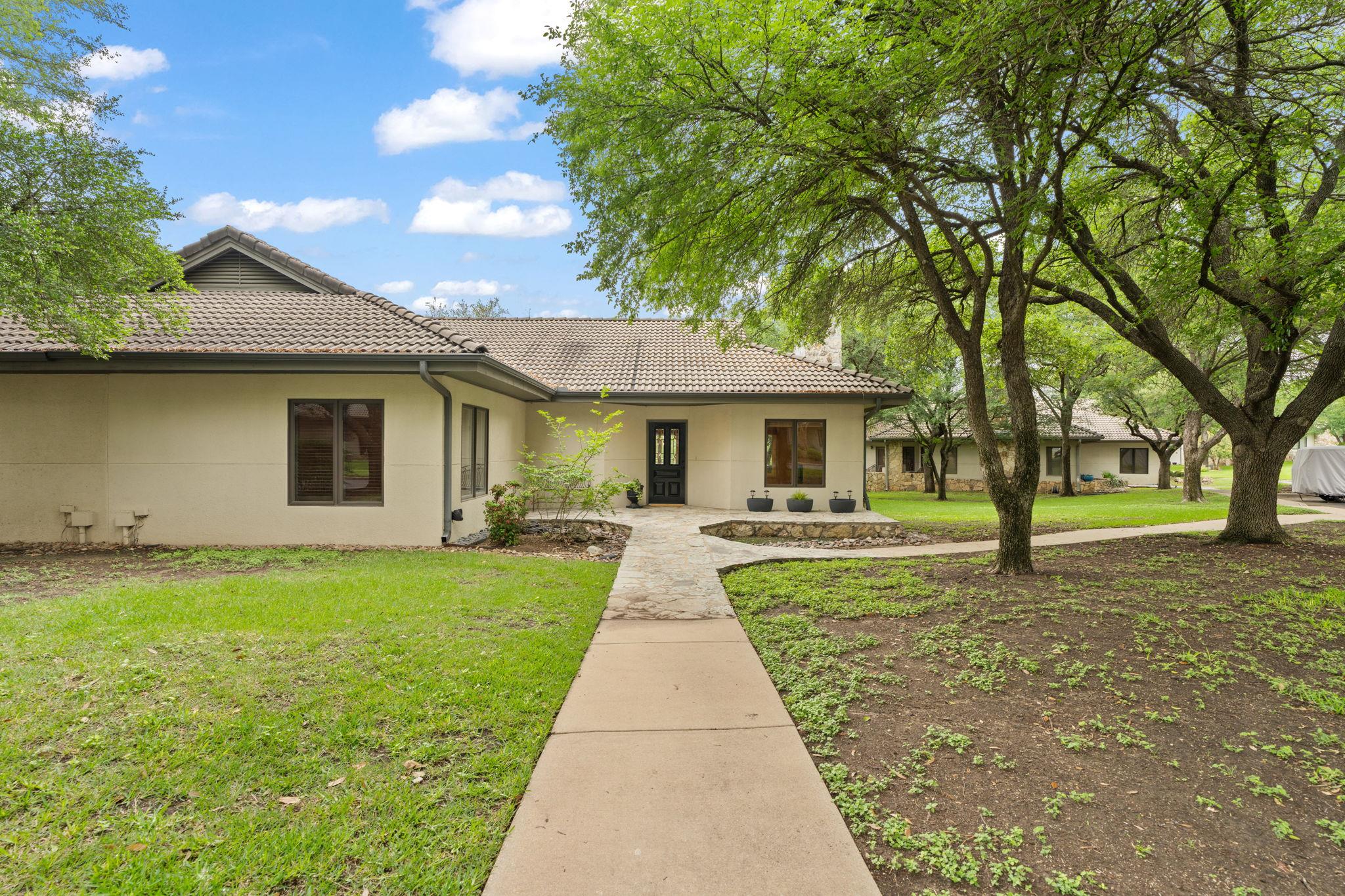 Stucco exterior with a tiled roof, featuring a da