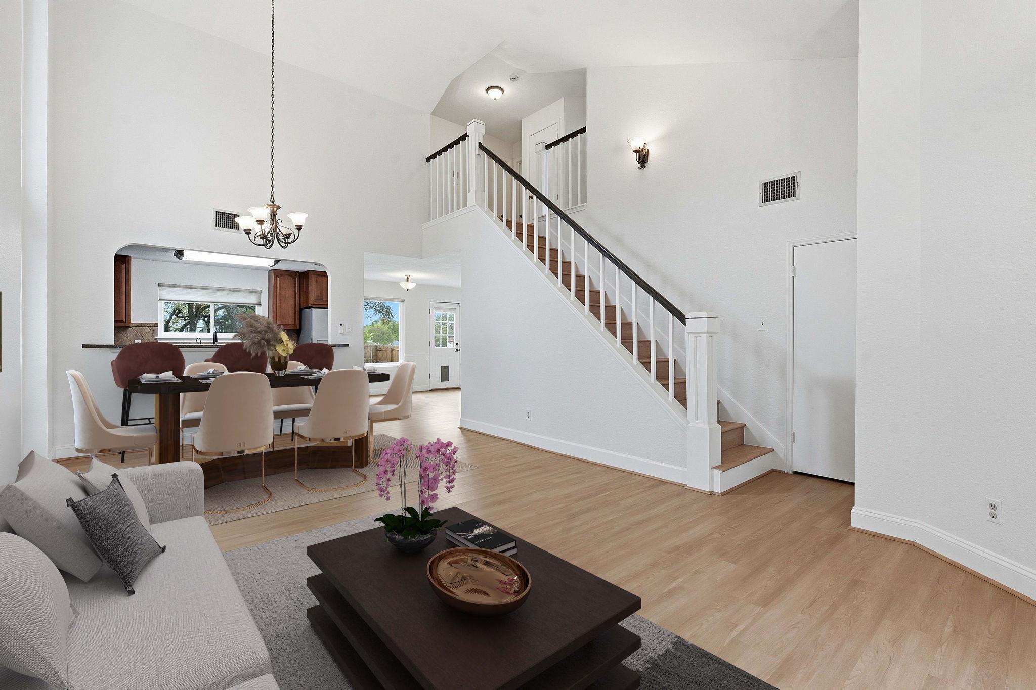 Open-concept living area featuring high vaulted c