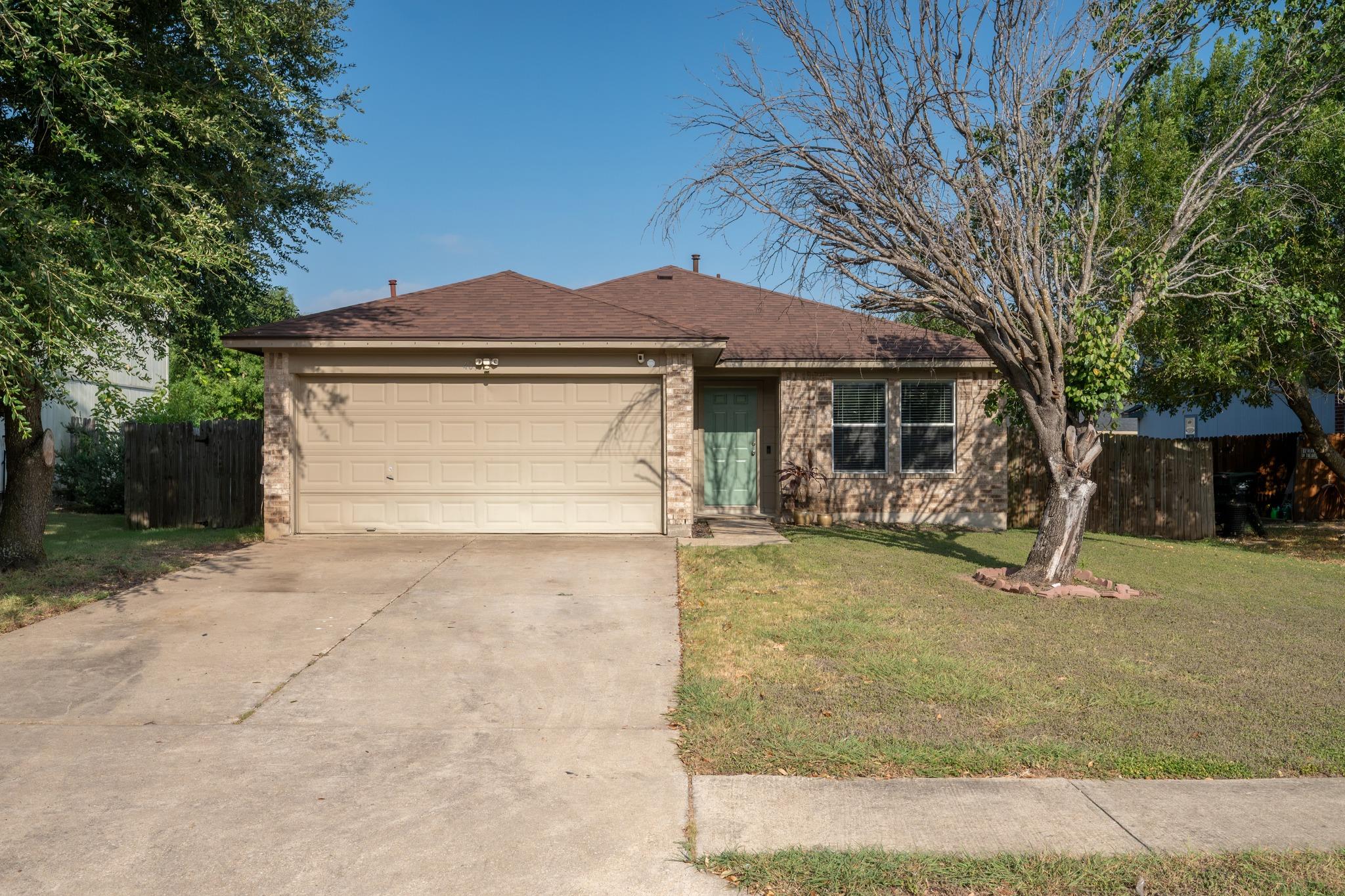 A classic brick exterior and a paved driveway wel