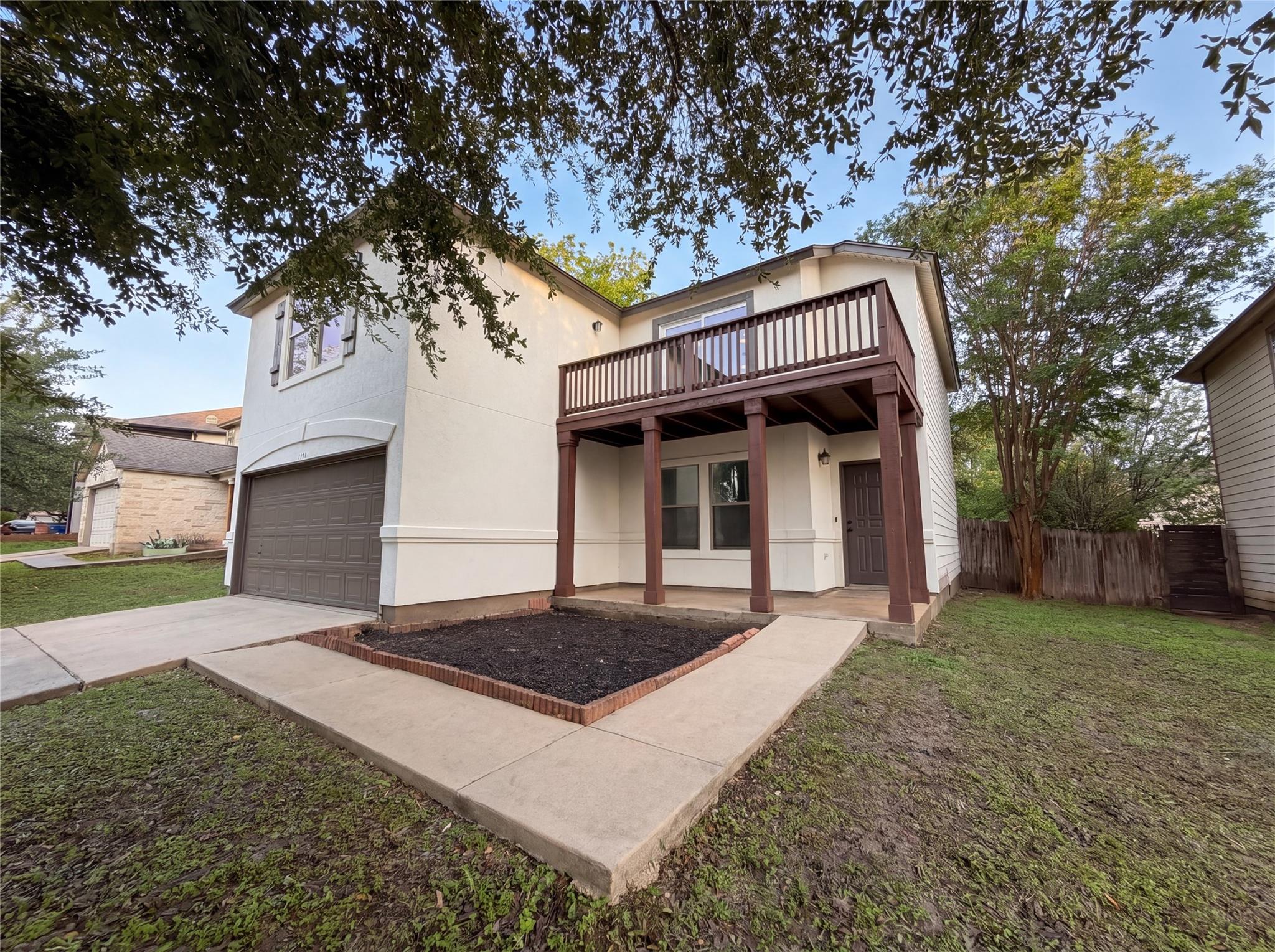 Two-story exterior featuring a private upper-leve