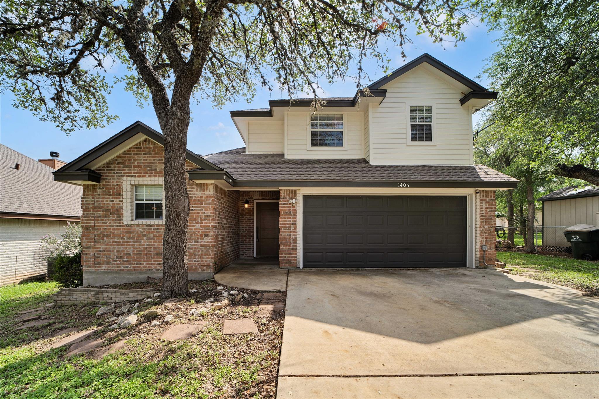 Brick and siding exterior with a dark asphalt shi