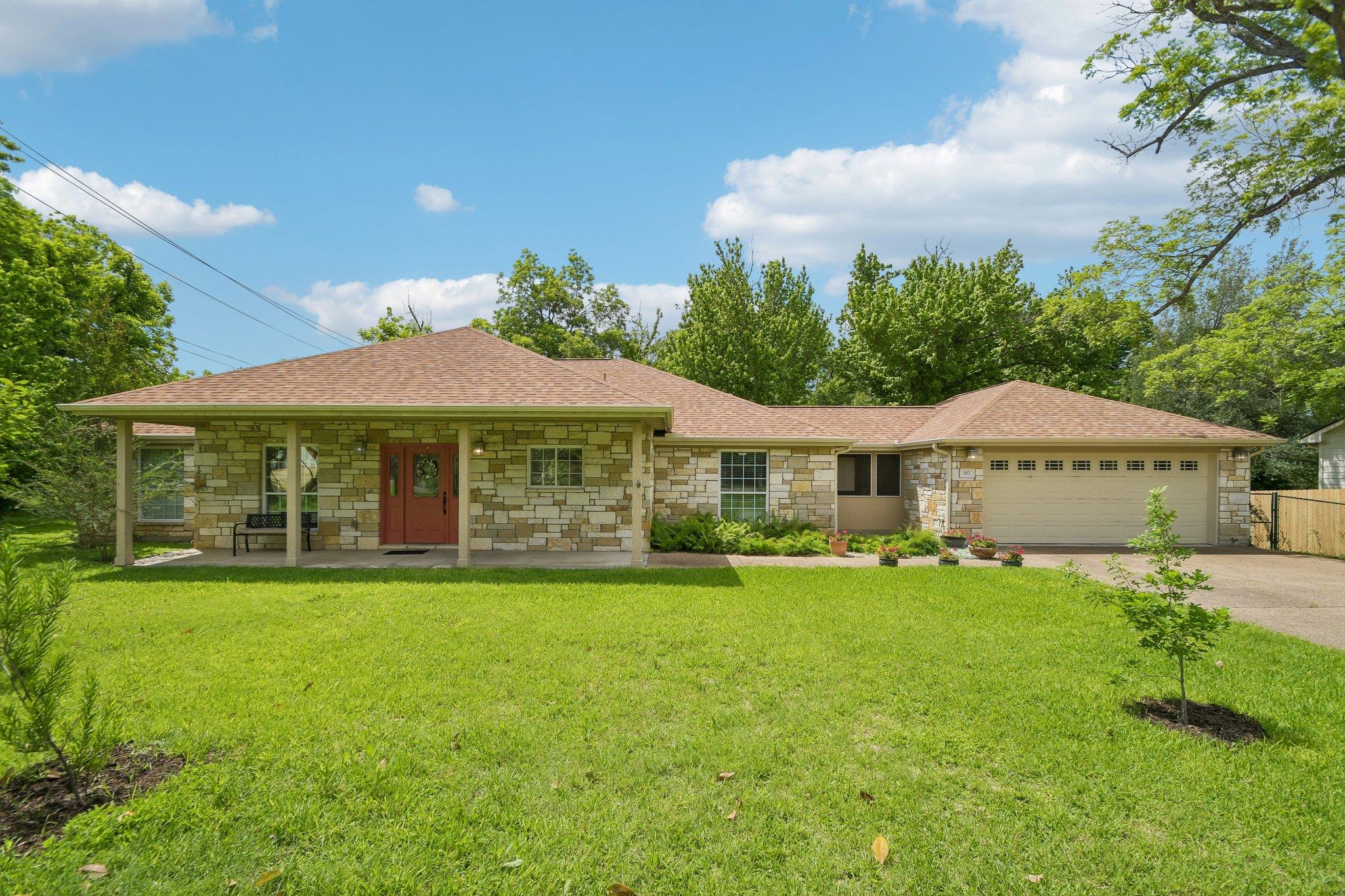 Stone veneer exterior with a covered porch, a red