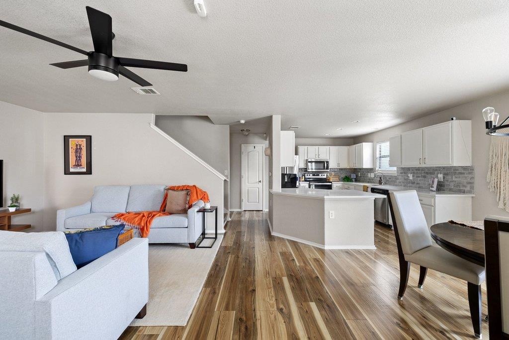Open-concept living space featuring wood-finish f