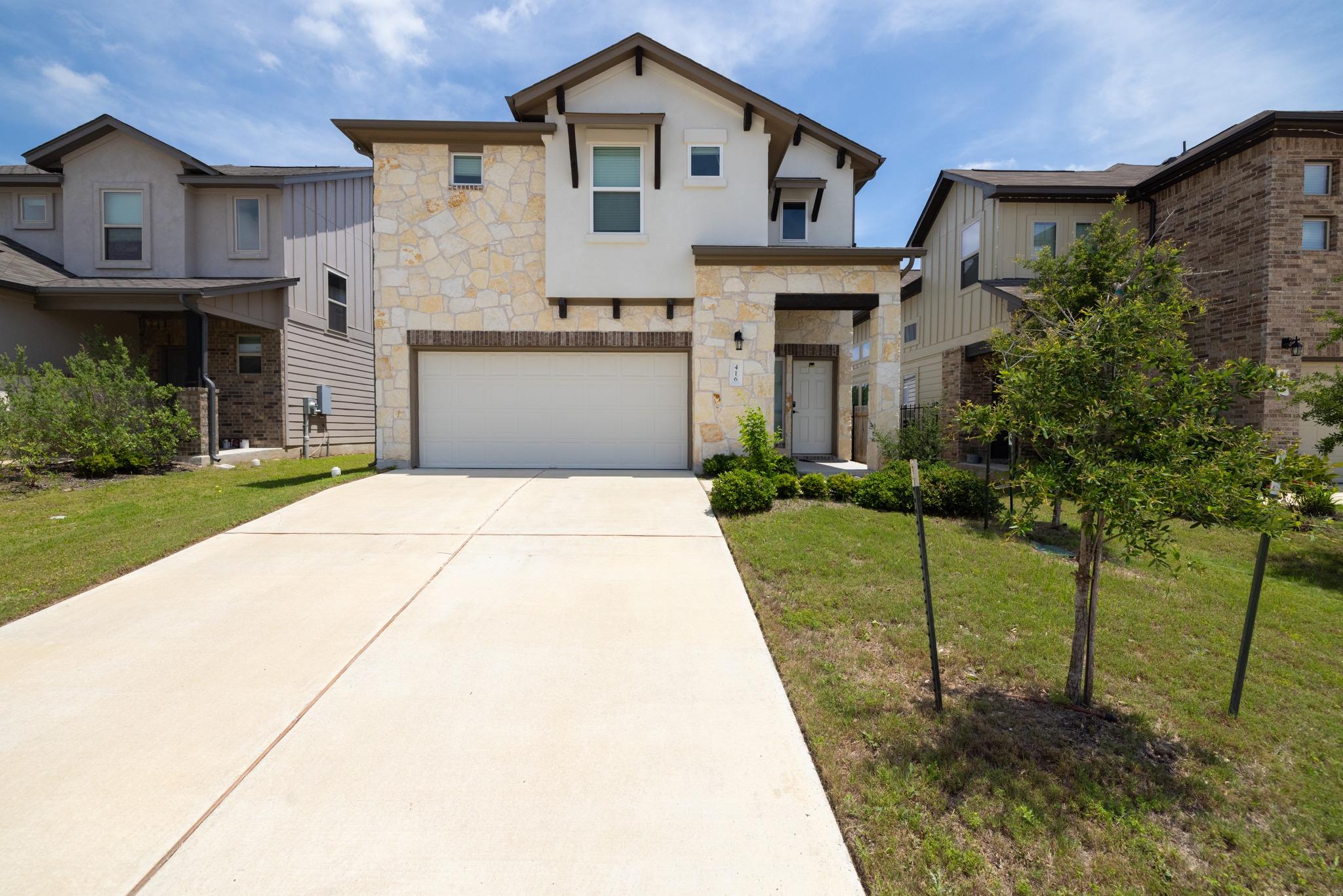 Exterior featuring stone and stucco facade, a two