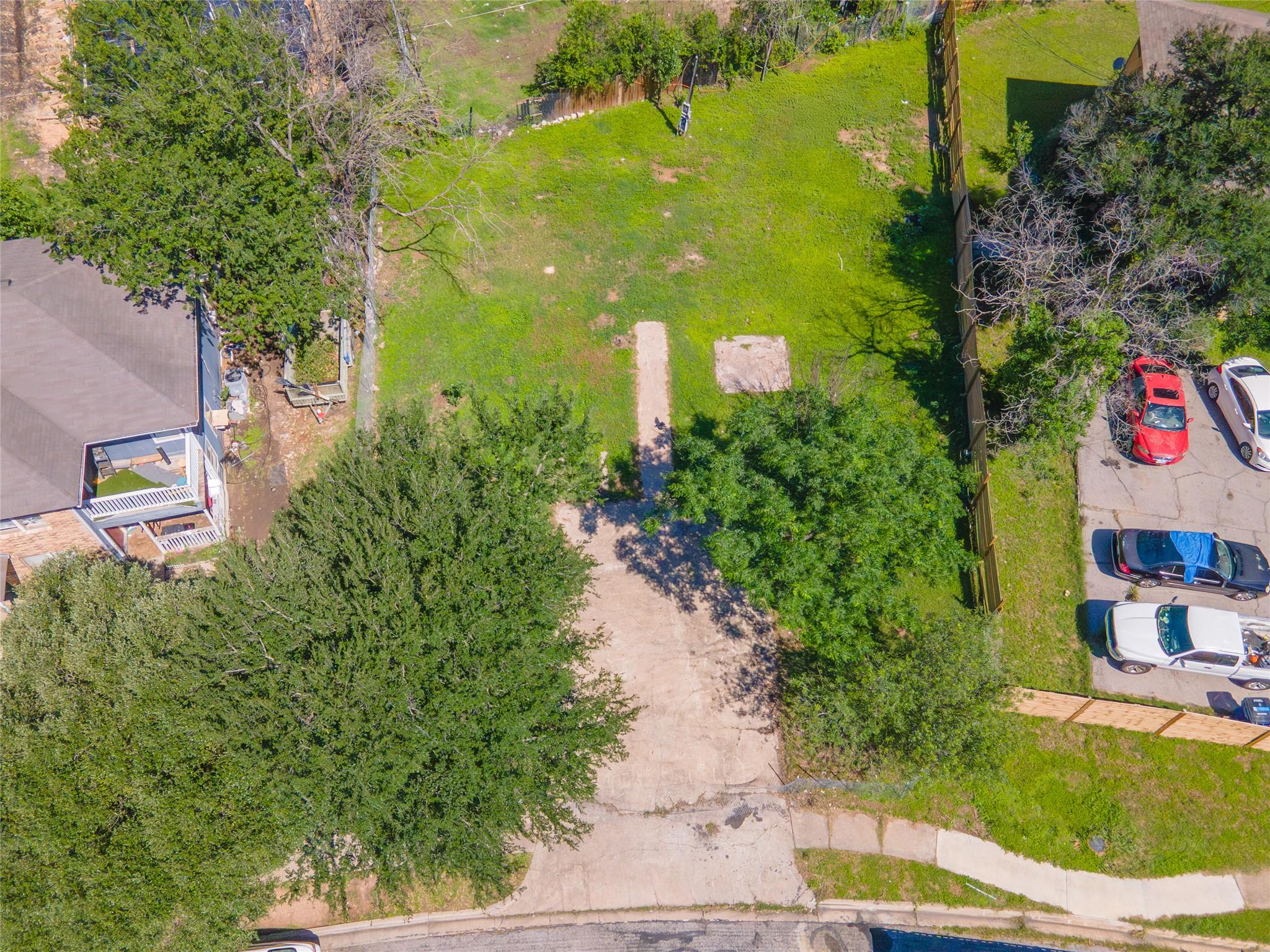 Cleared residential lot featuring mature trees an