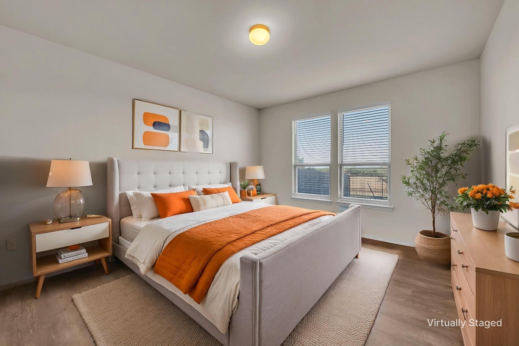 Plush, tufted headboard and natural wood flooring