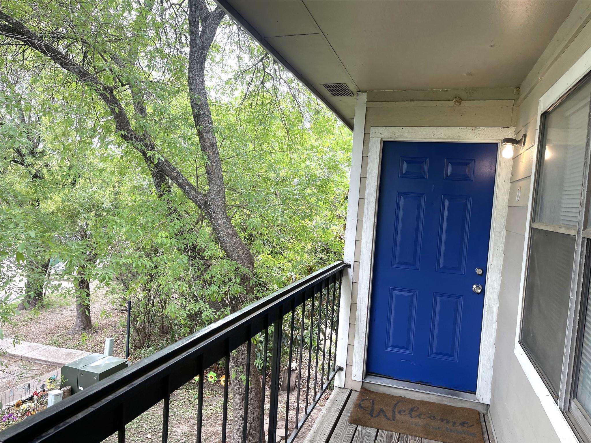 Balcony entry featuring a vibrant blue paneled do