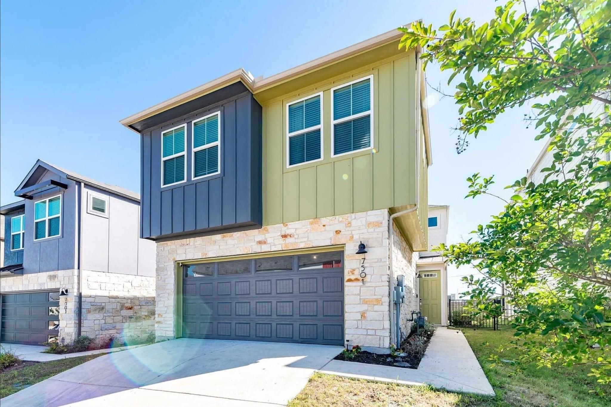 Modern multi-story exterior featuring a stone fac
