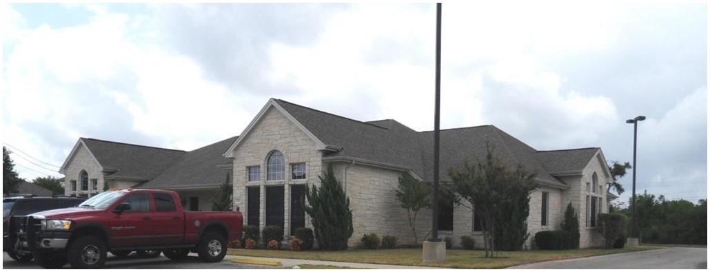 Limestone exterior with a shingled roof
