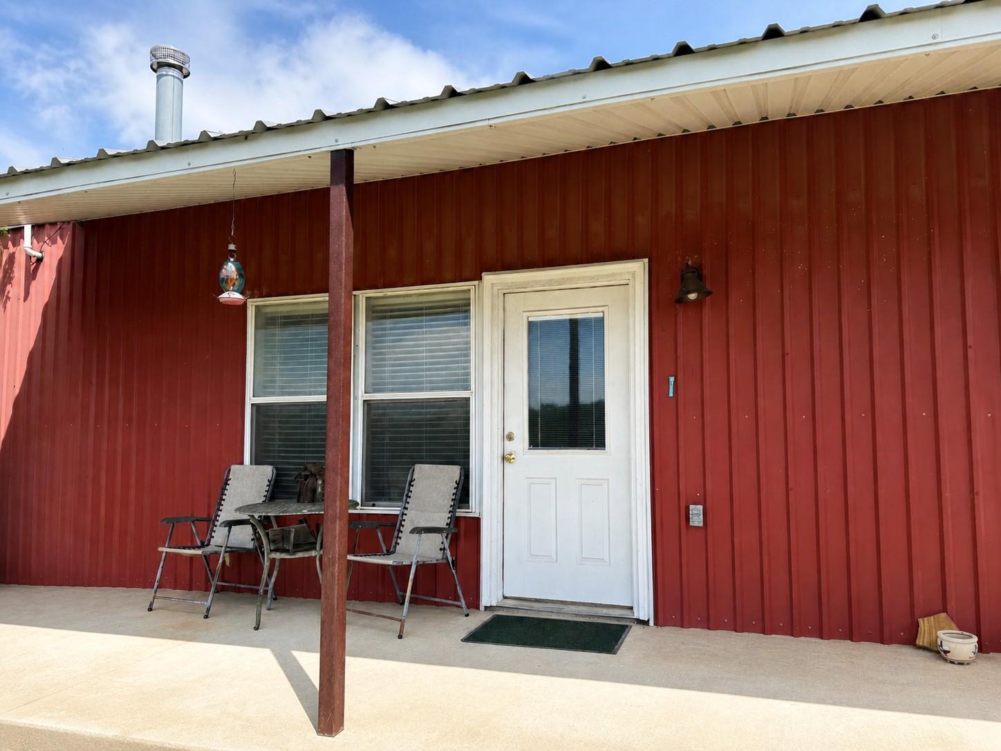 Exterior featuring red corrugated metal siding an