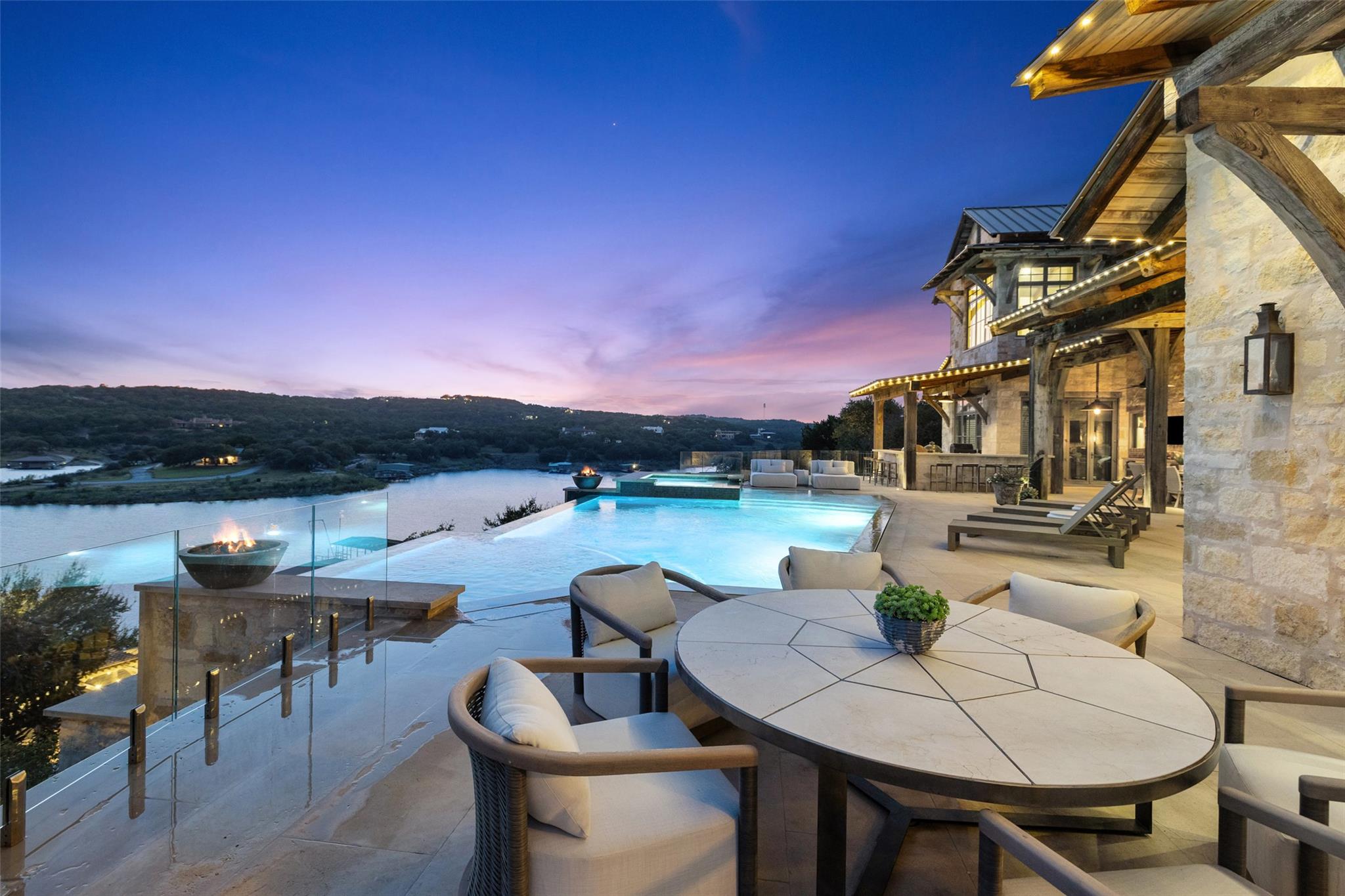 An expansive multi-level stone terrace surrounds 
