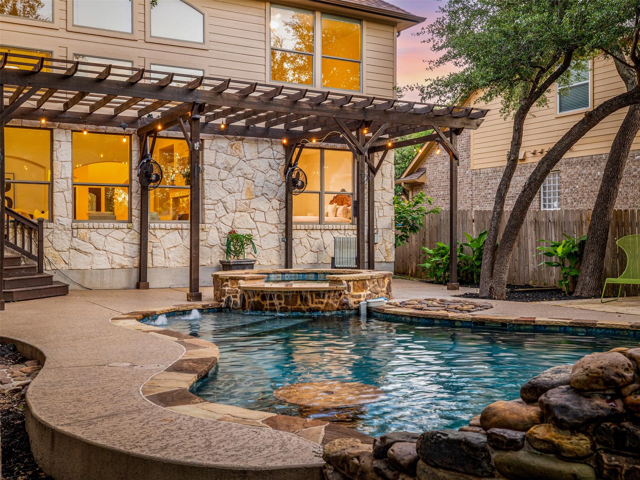 Outdoor living area featuring a custom-shaped poo