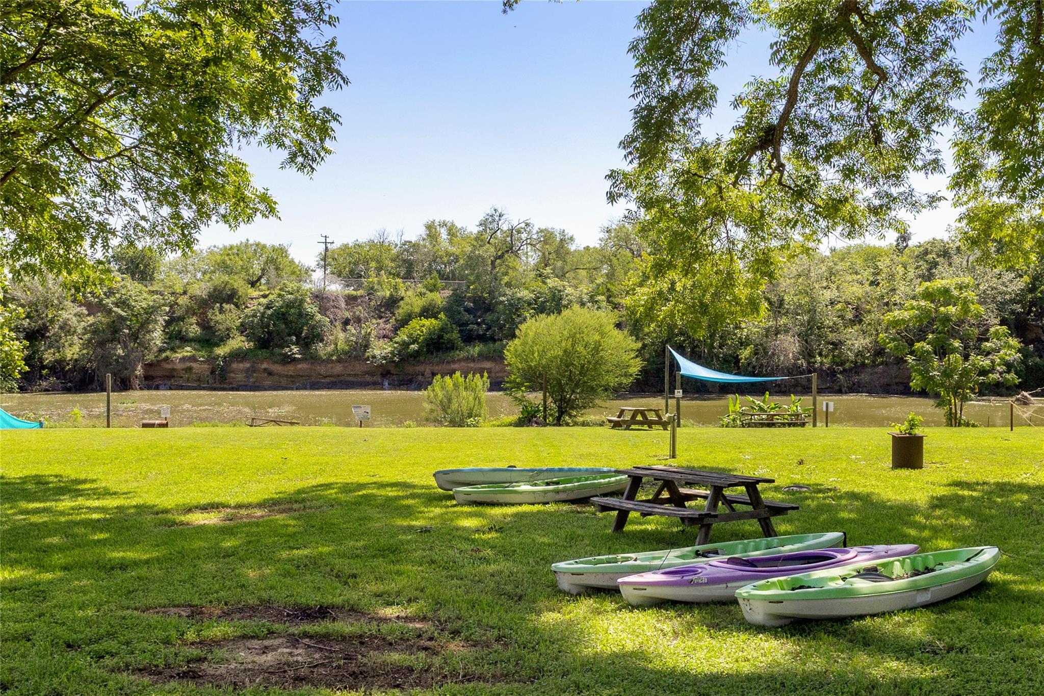A verdant lawn gracefully slopes to the water's e