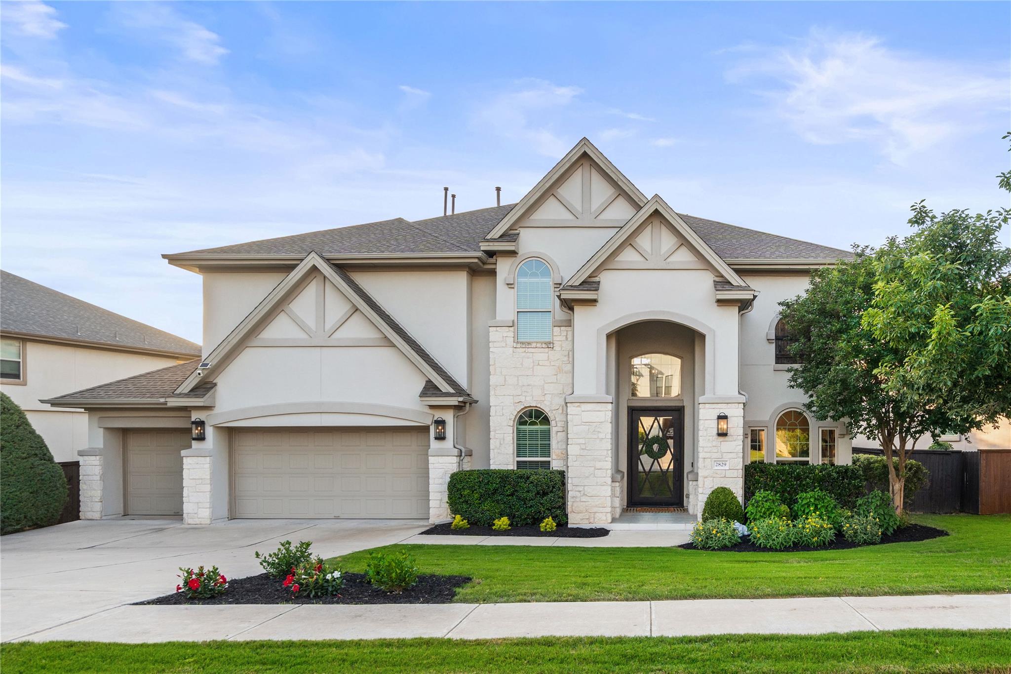 Gable rooflines and stone accents define this ele