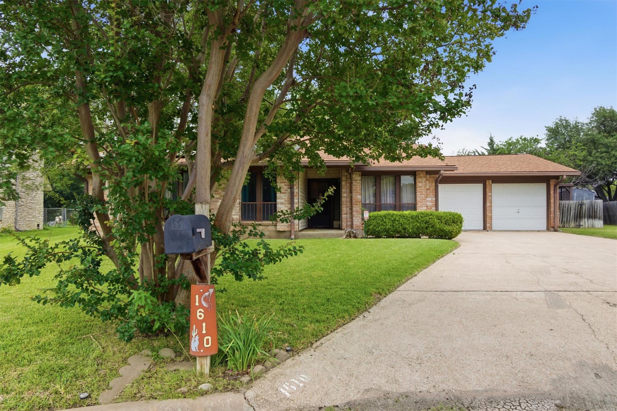 Brick exterior residence featuring a two-car gara