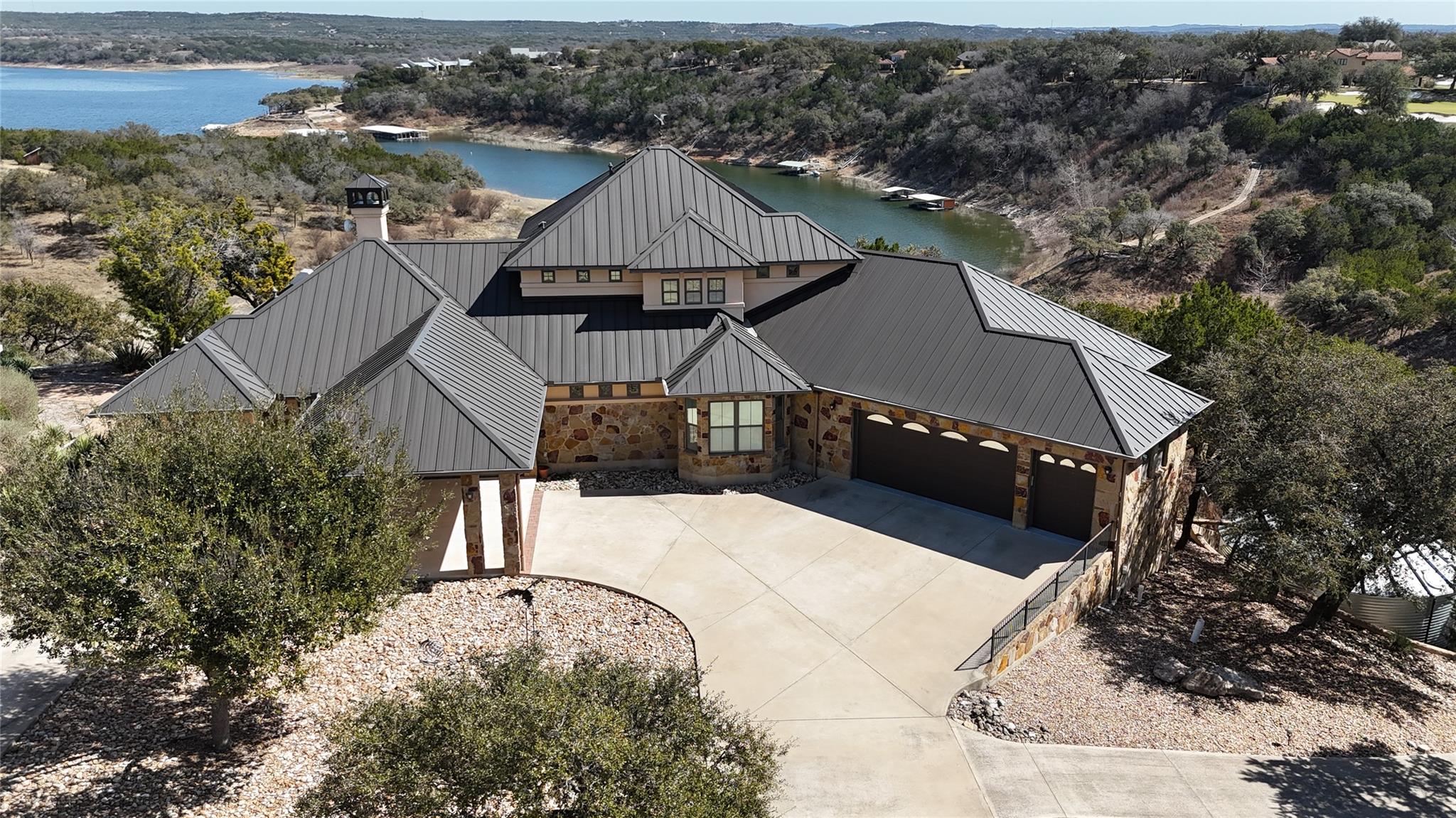 Stone and stucco exterior with a multi-gabled met