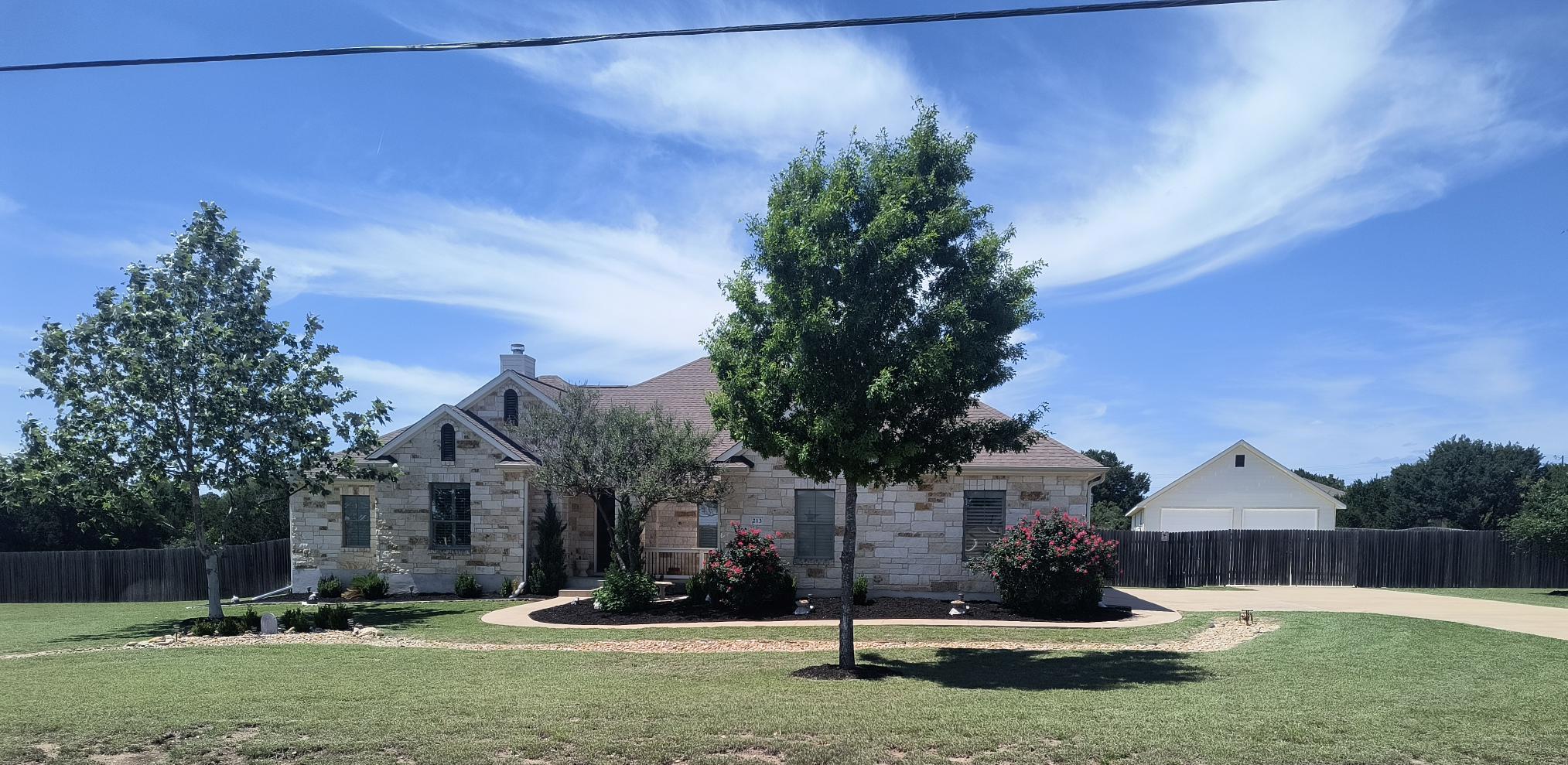 Stone exterior residence with a gabled roof and c