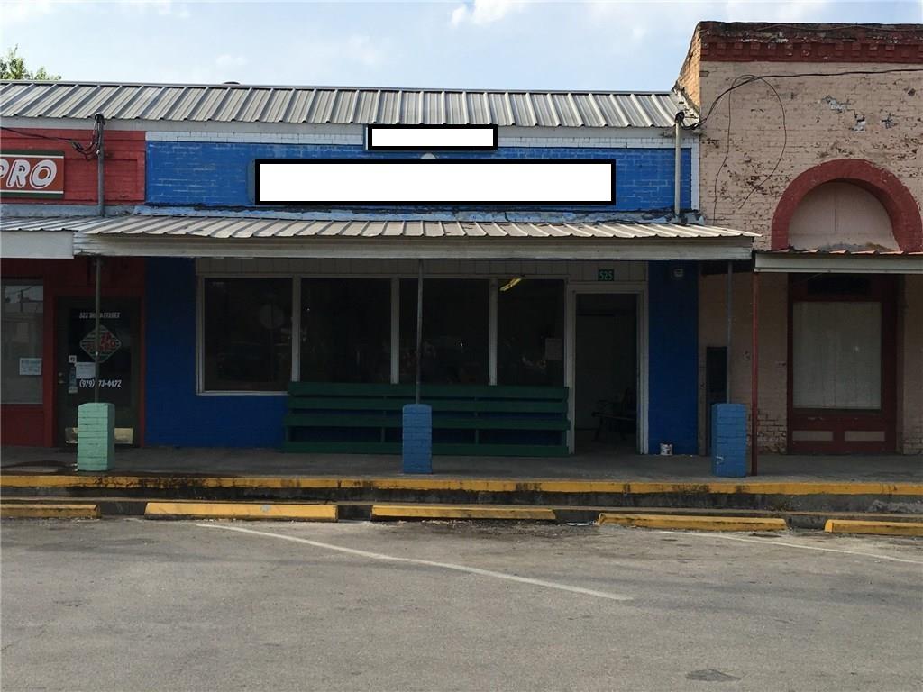 Retail storefront featuring a metal roof and pain