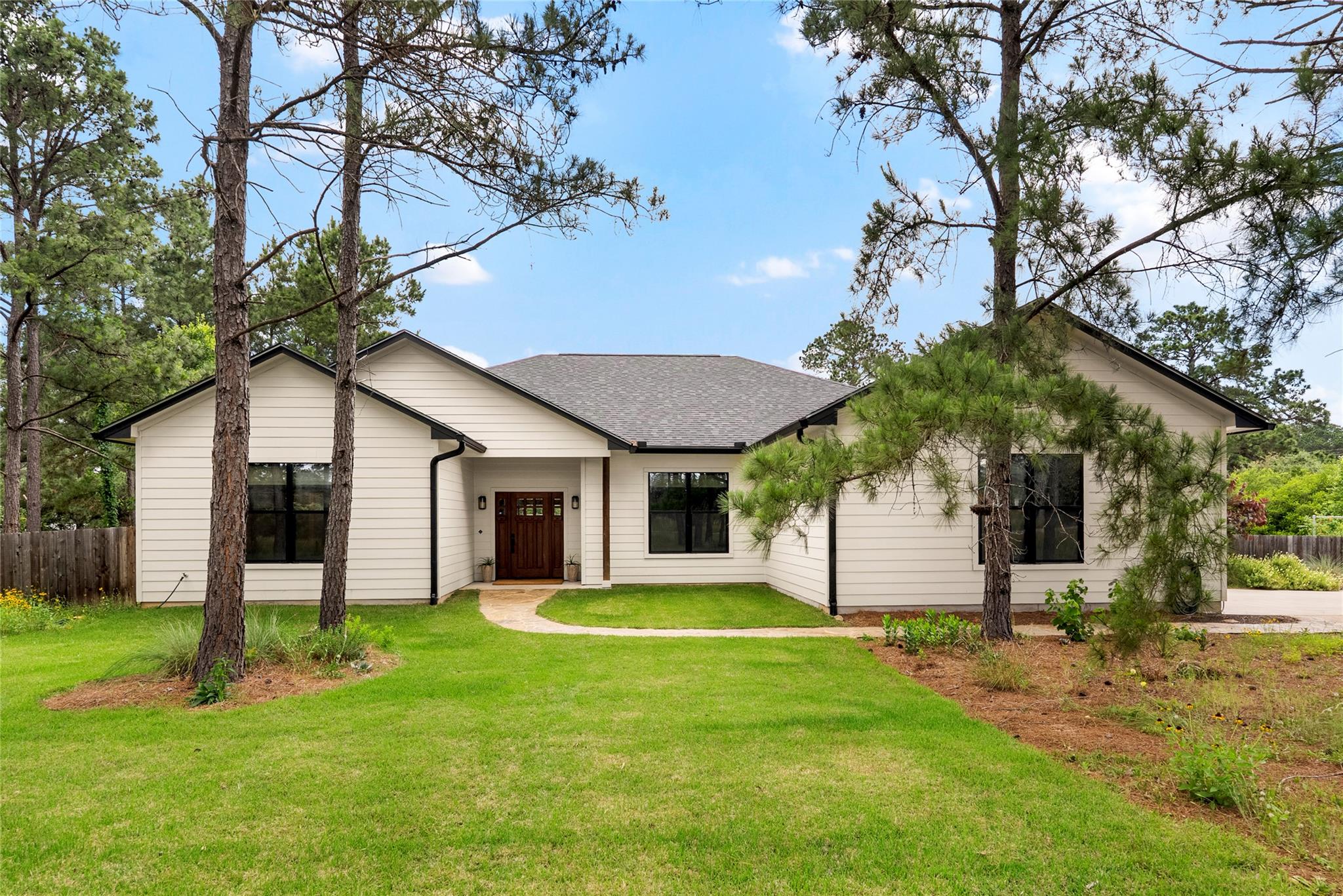 Contemporary white siding exterior with a dark sh