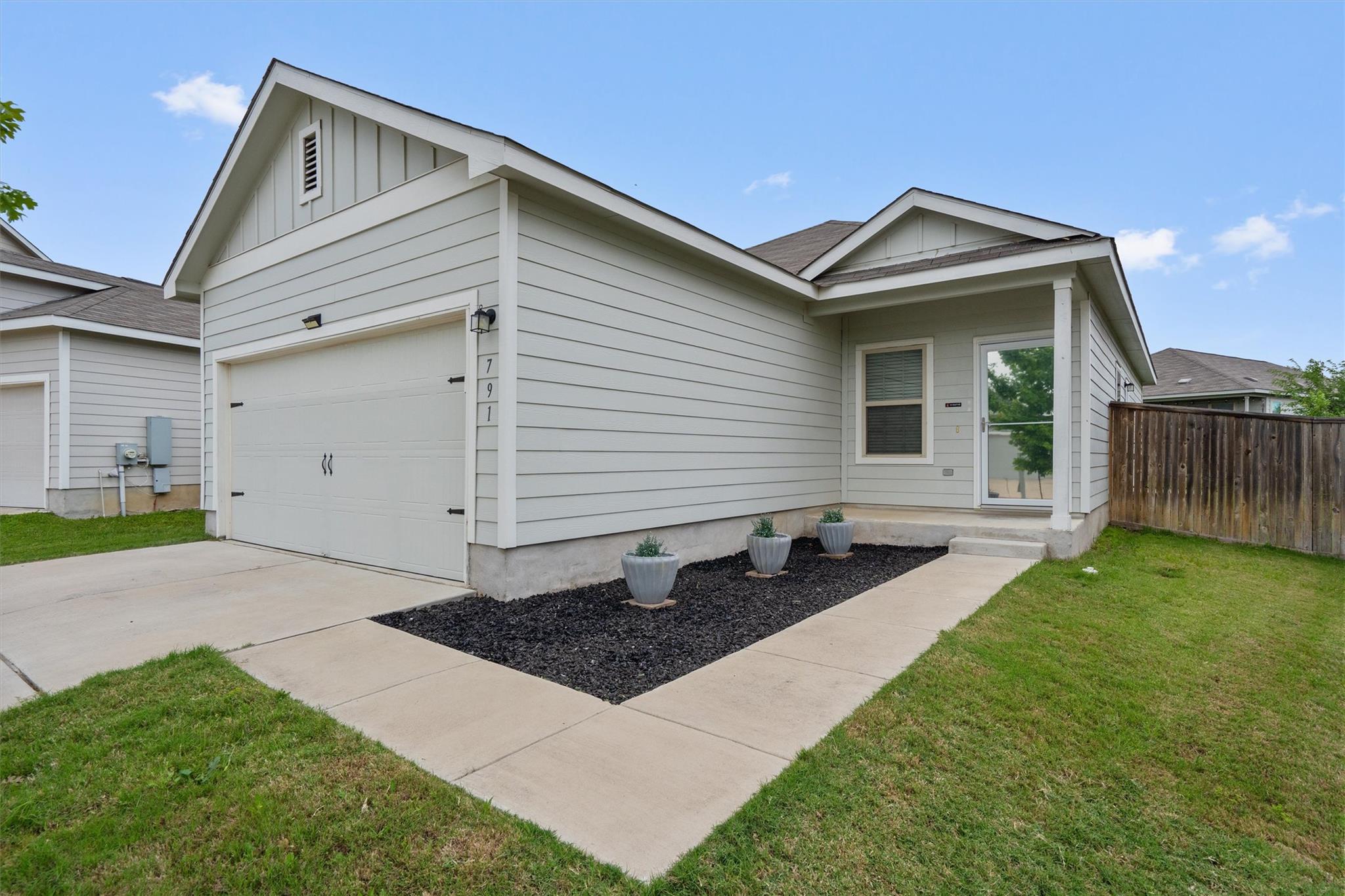 A well-kept front yard and covered entryway defin