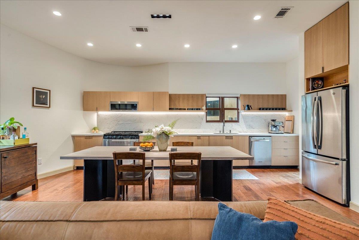 Open-concept kitchen featuring wood-finish cabine