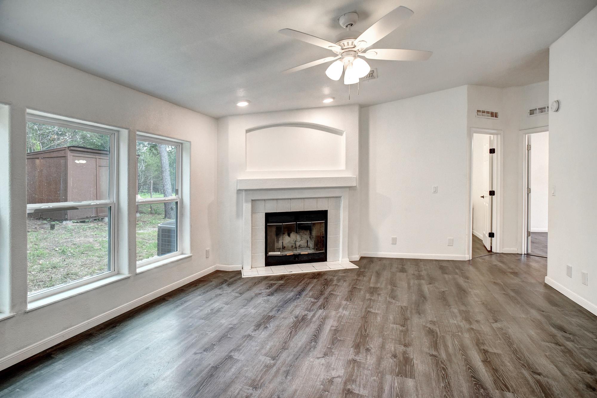 Living area featuring a fireplace with a white ti
