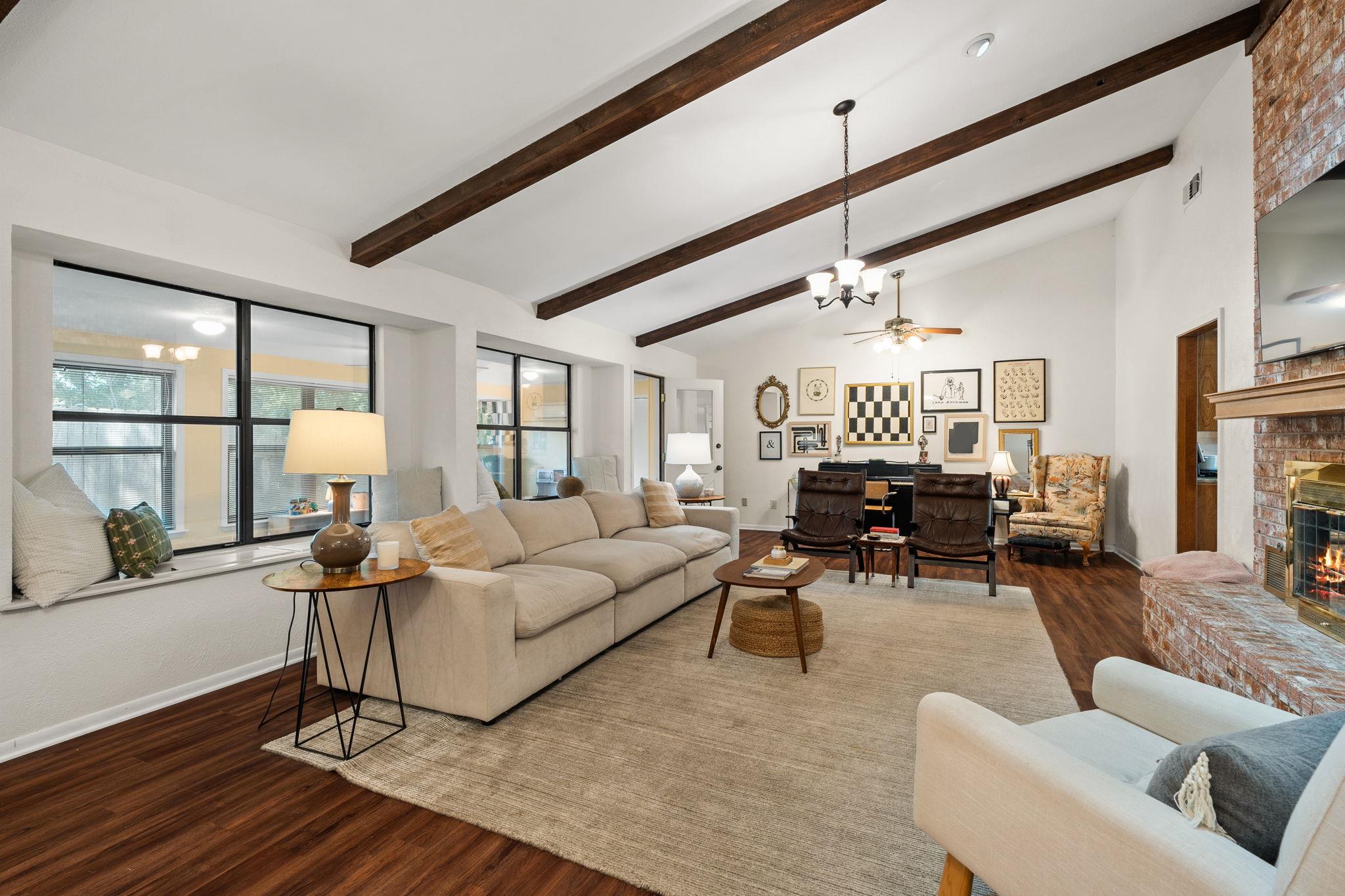 Vaulted ceilings with exposed wood beams define t