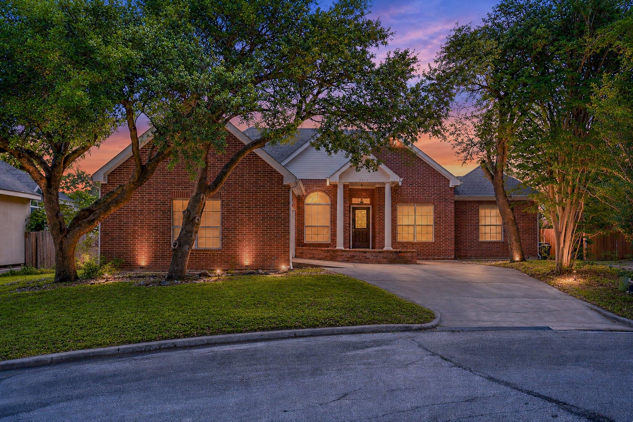 Brick exterior residence featuring a covered entr