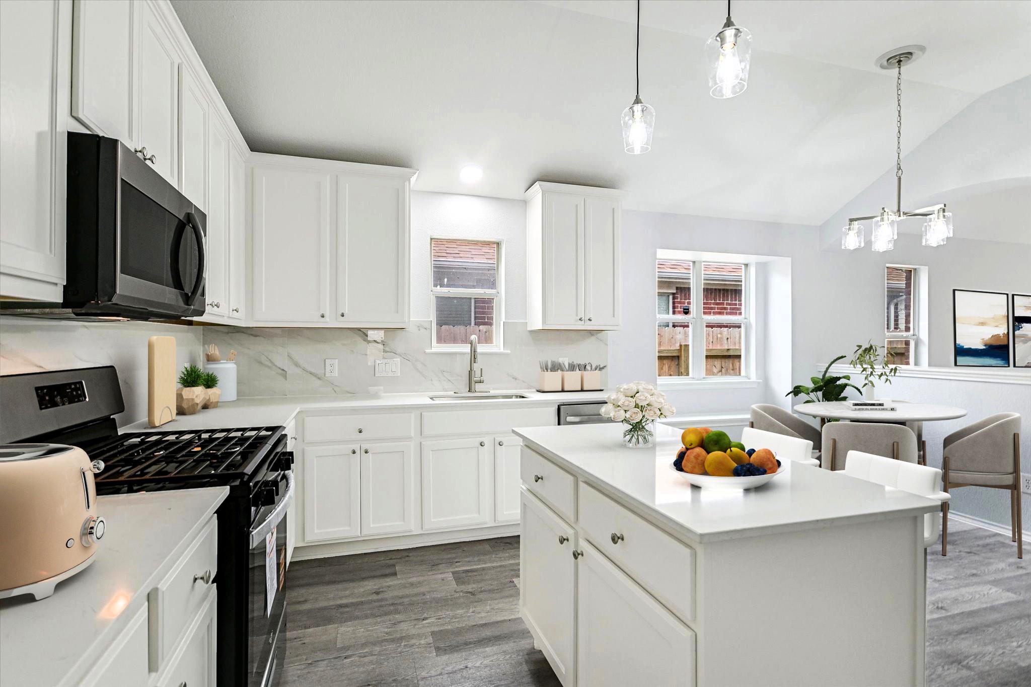 Modern kitchen featuring white cabinetry, light-t