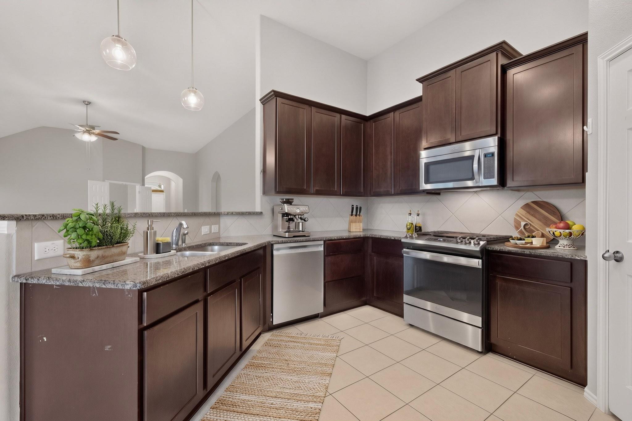 Rich wood cabinetry and granite countertops ancho